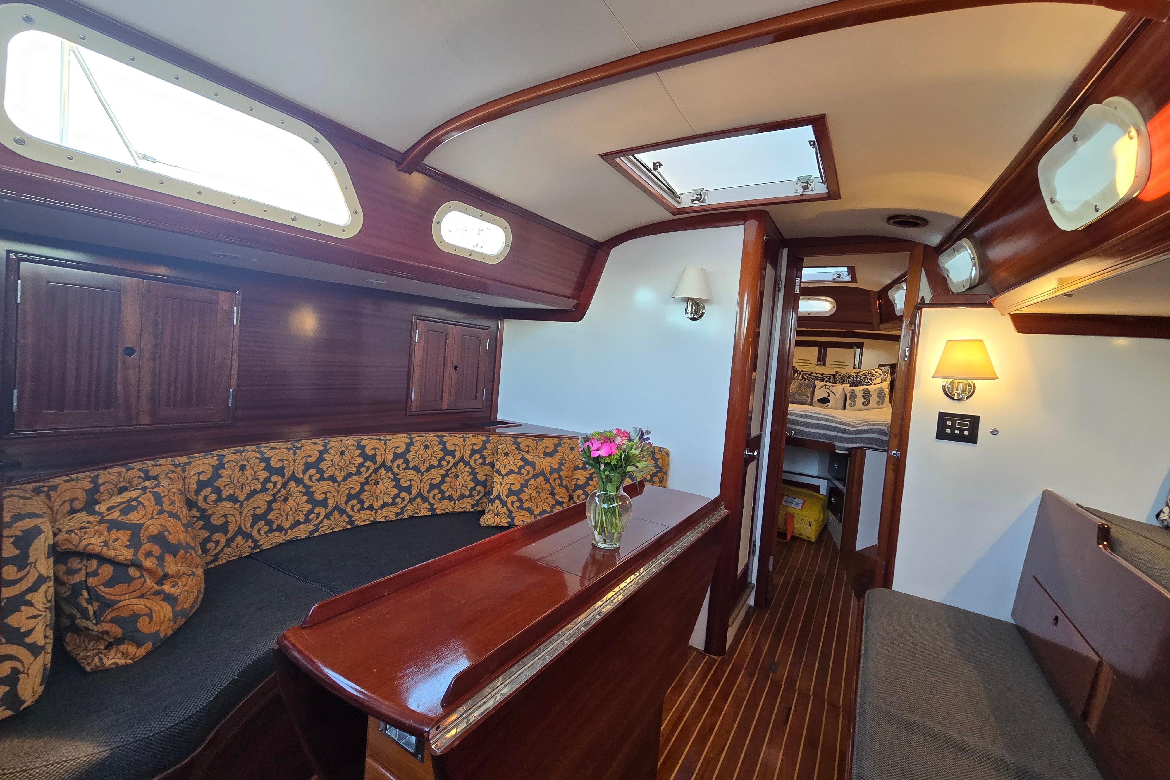 Interior of a 1970 Hinckley Bermuda 40 sailboat with elegant wood finish and cozy seating.