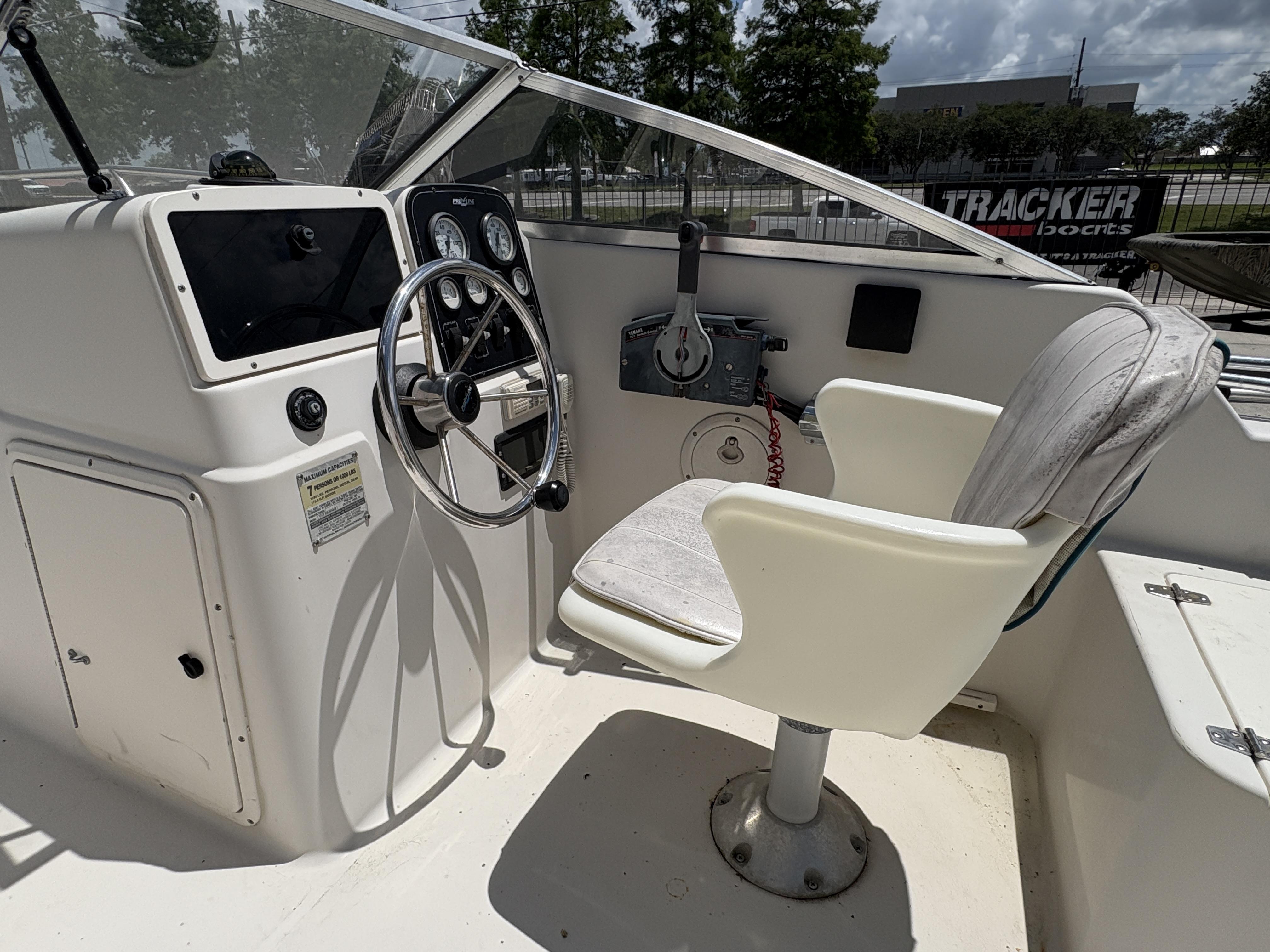 1996 Pro-Line 202 boat cockpit with steering wheel and captain's chair.