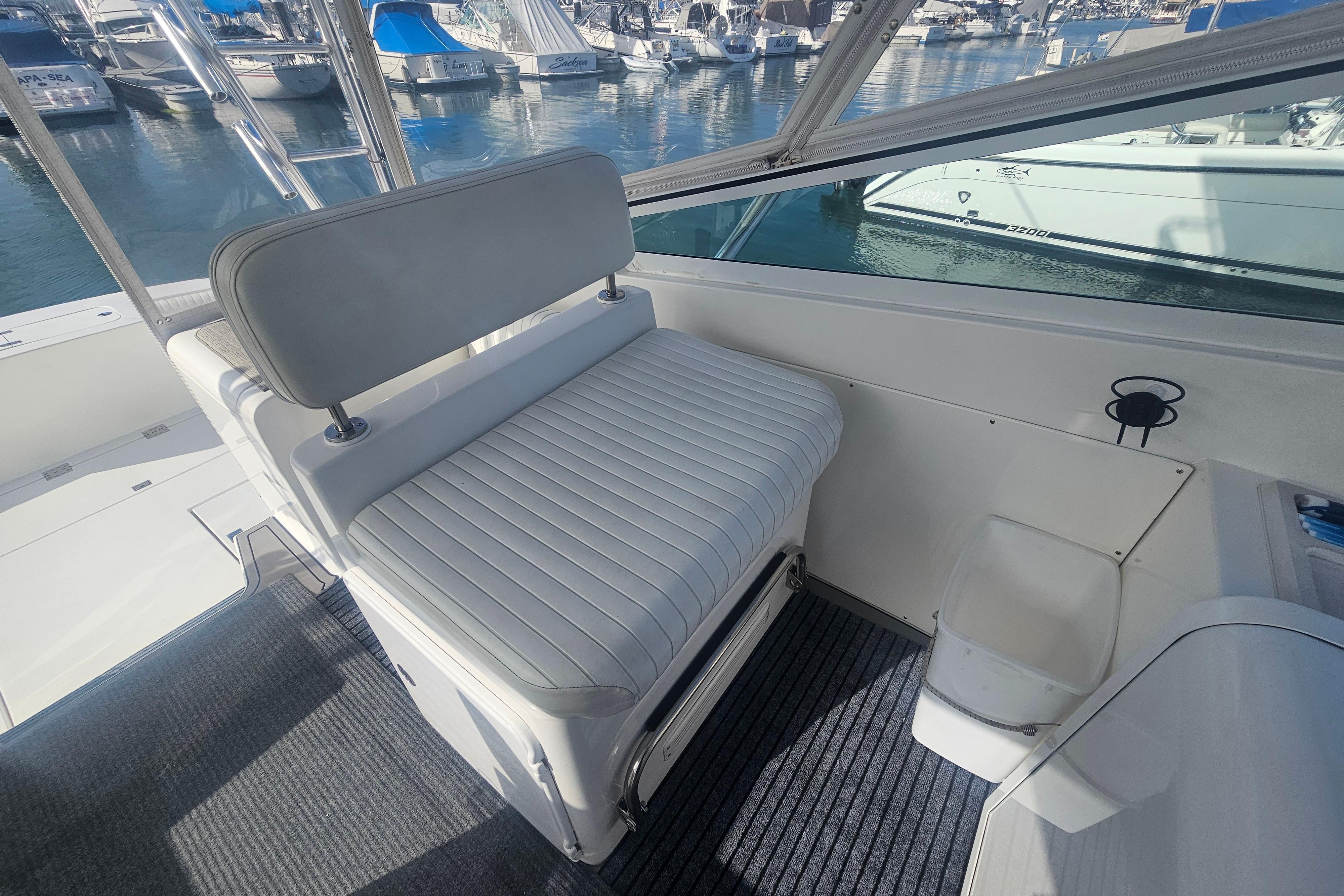 2003 Topaz 32 Express boat interior with cushioned seating and marina view.