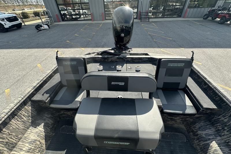 2023 Havoc 1756 MRST boat interior with seating and motor, parked outdoors.