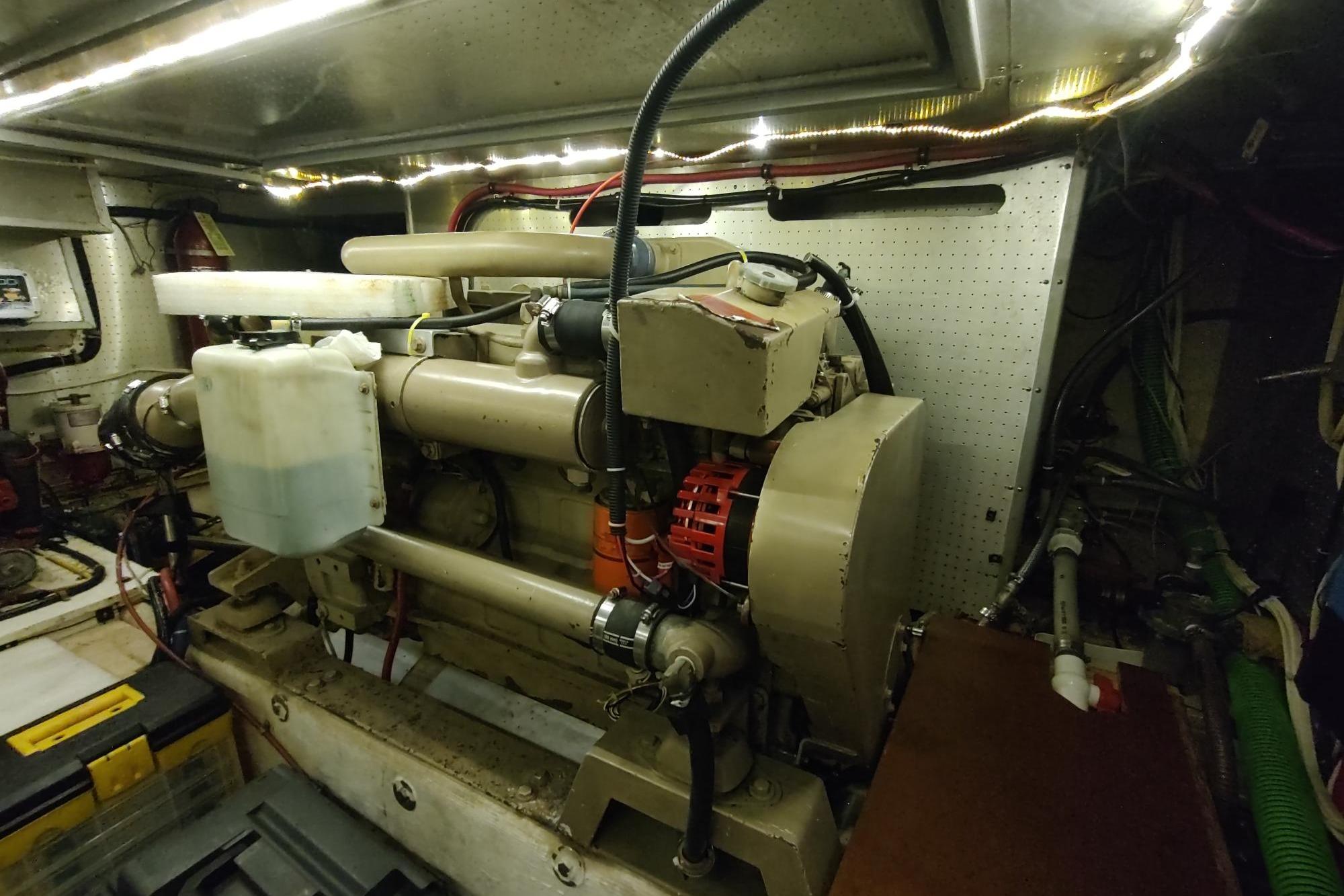 Engine room of a 1989 Hyatt Double Cabin Motoryacht, showcasing mechanical components.