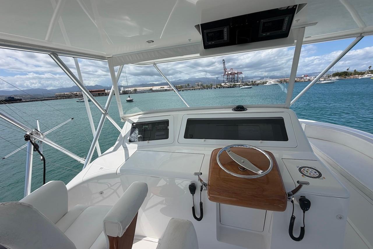 Helm of 2012 Viking 50 Convertible yacht overlooking marina and ocean.