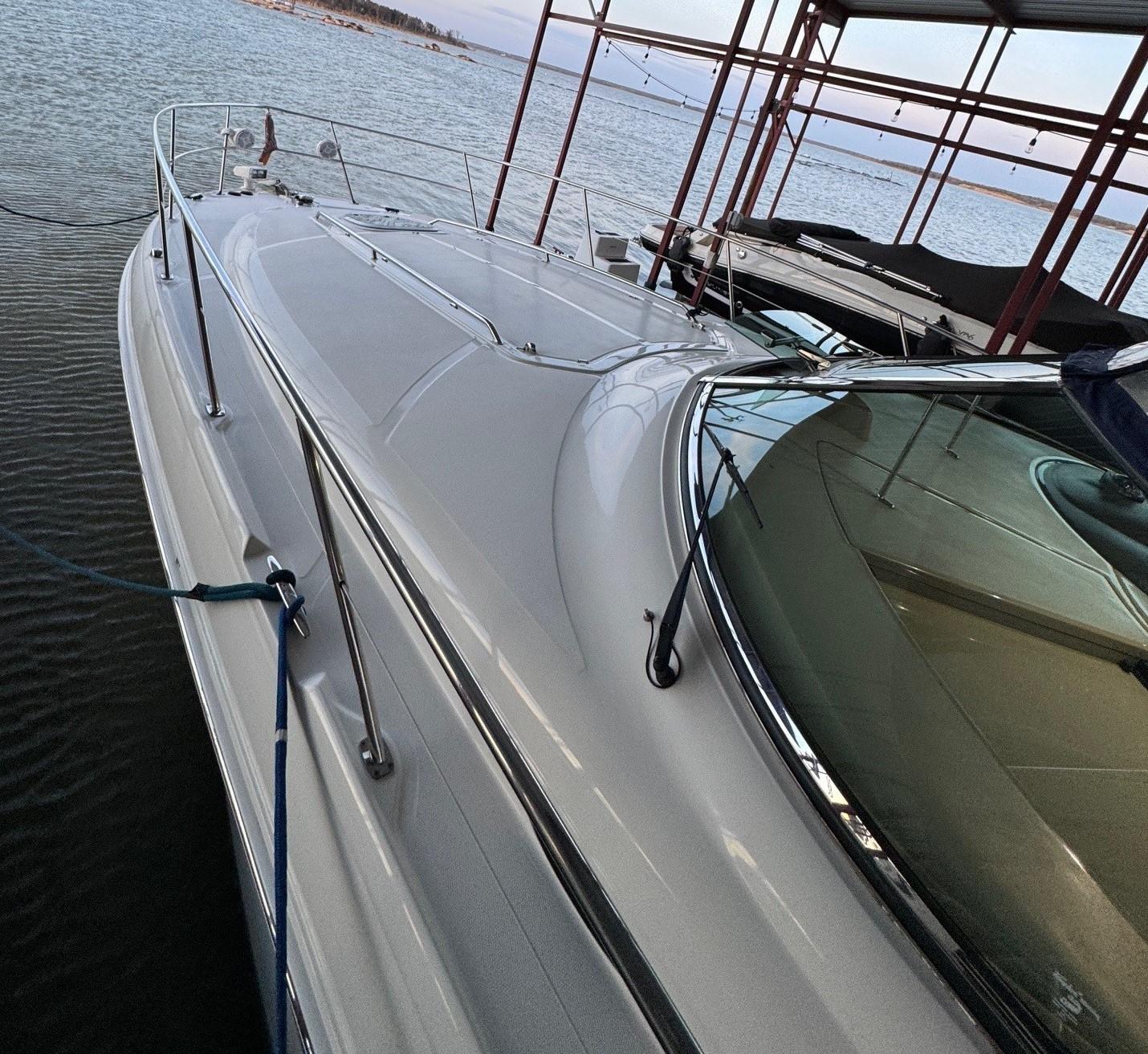 2007 Sea Ray 38 Sundancer yacht docked by the water.