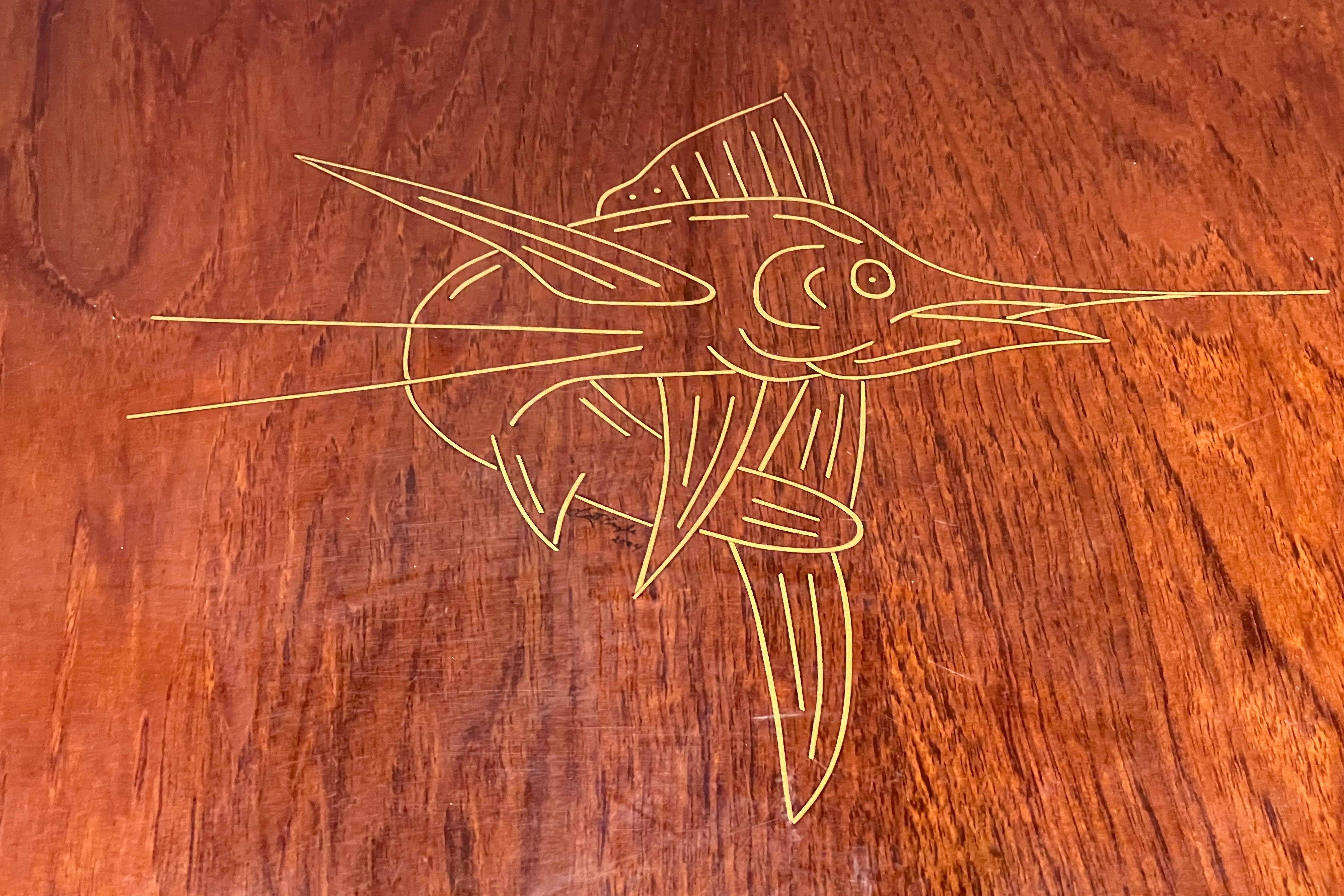 Wooden surface with a marlin line art engraving, Pursuit 2870 Walkaround 2004.
