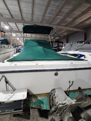 2000 Renken Seamaster 2288 WA boat with green cover in storage.