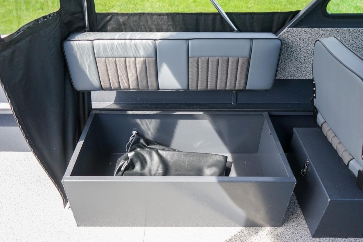 Interior storage compartment of 2026 Alumaweld X202 Stryker boat, featuring cushioned seating.