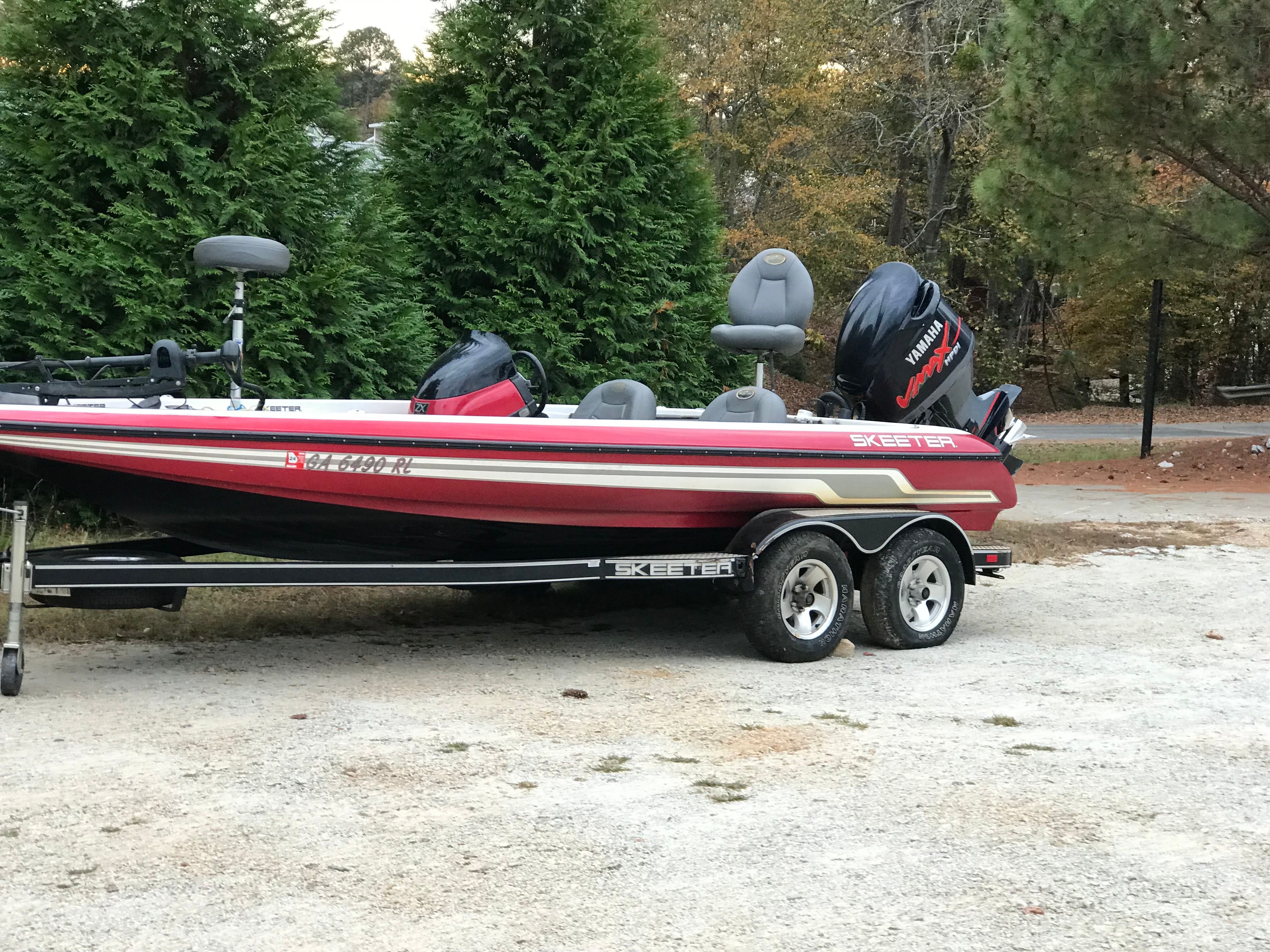 2007 Skeeter ZX200 boat on trailer, surrounded by trees.