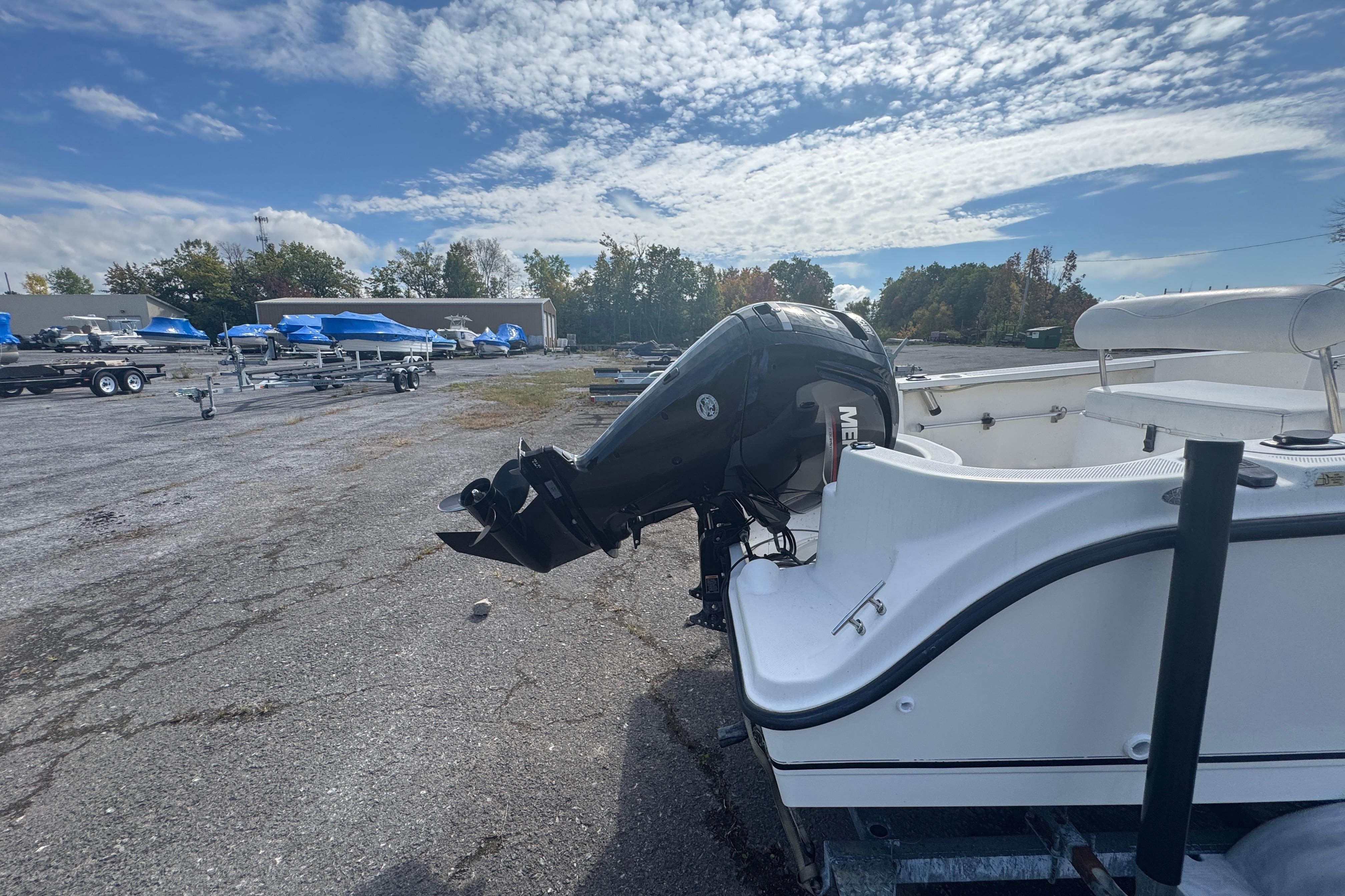 2007 Trophy 1703 Center Console boat with outboard motor in a parking lot.