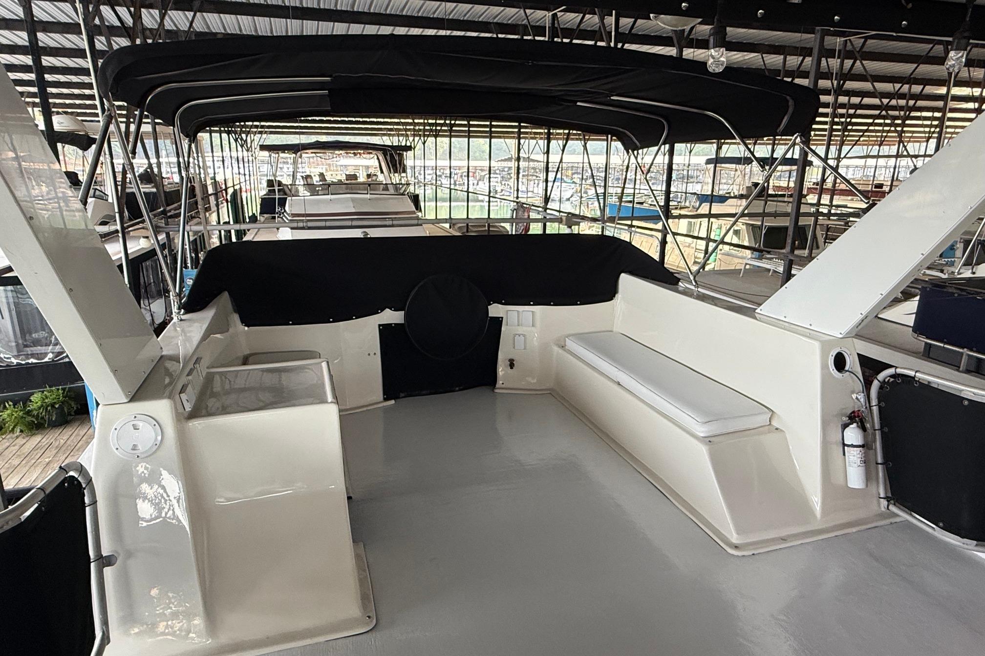 1998 Sumerset 16x76 houseboat interior with seating and canopy in marina.