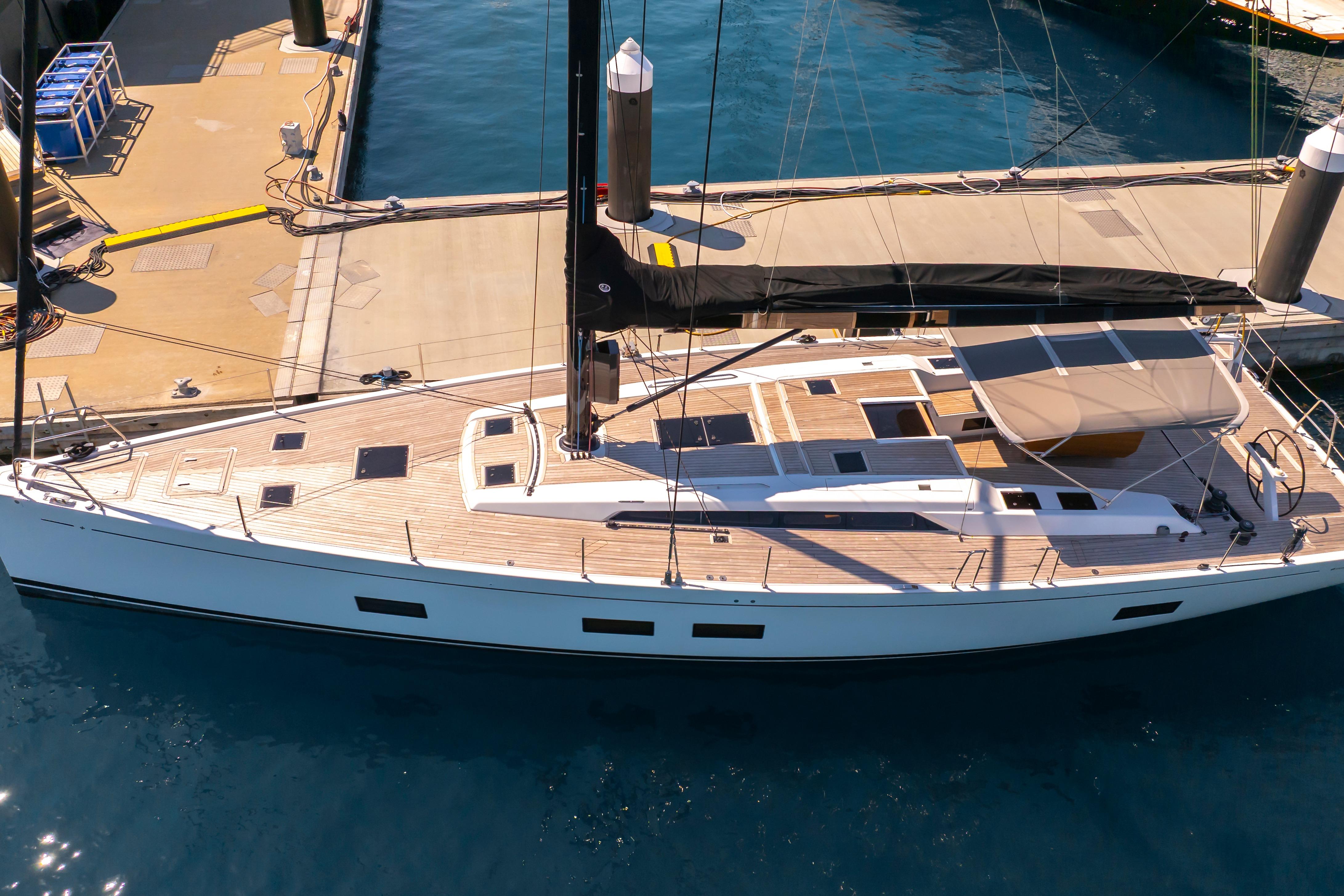 Grand Soleil 58 yacht, 2016 model, docked at marina with sleek design and wooden deck.