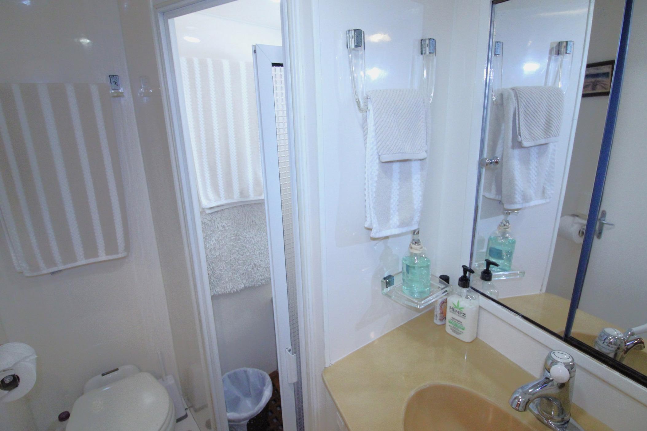 Bathroom interior of 1995 Jefferson 52 Rivanna Cockpit MY yacht, featuring sink and toiletries.