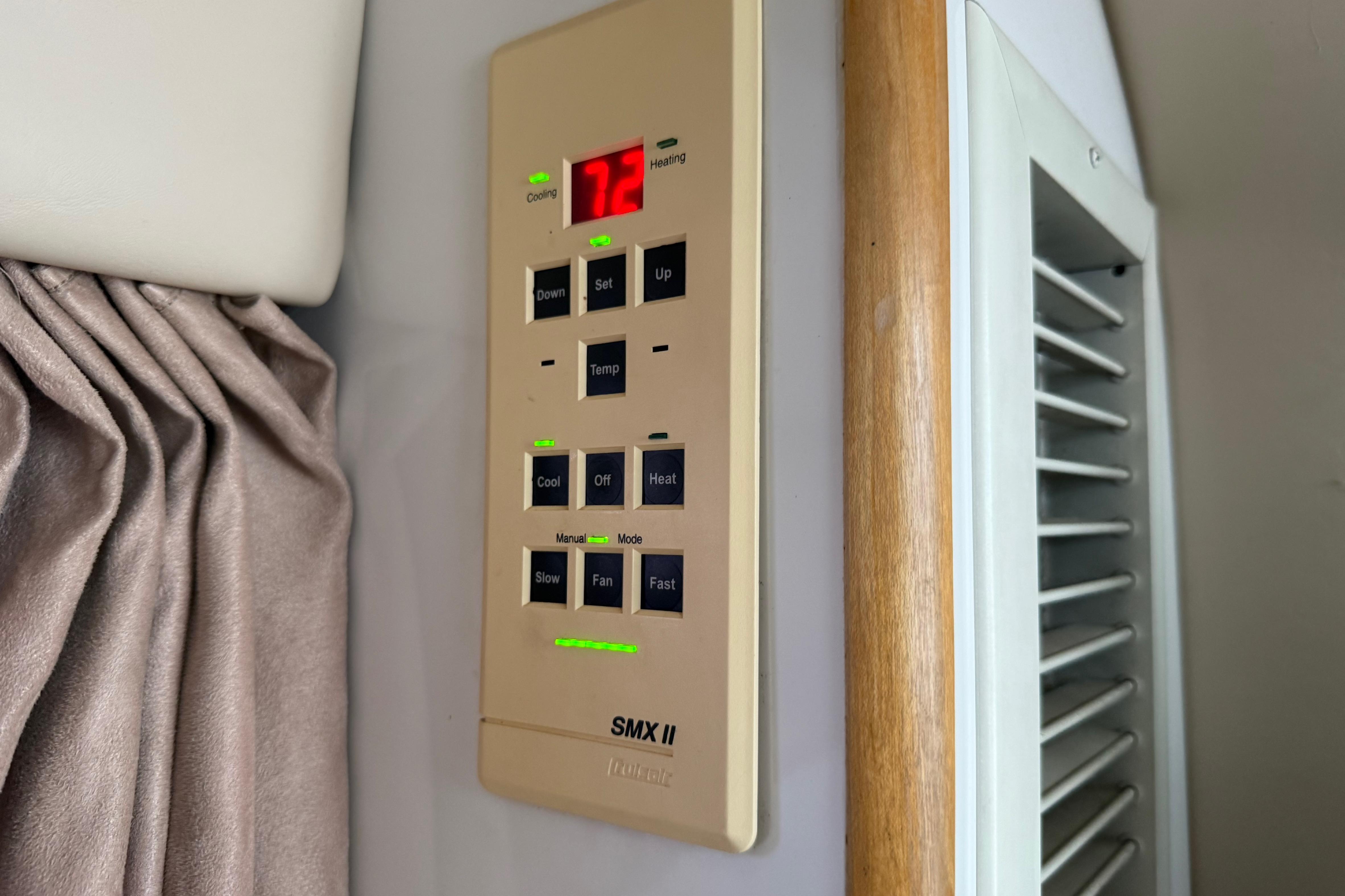 Thermostat control panel in a 1999 Chaparral Signature 300 boat cabin.