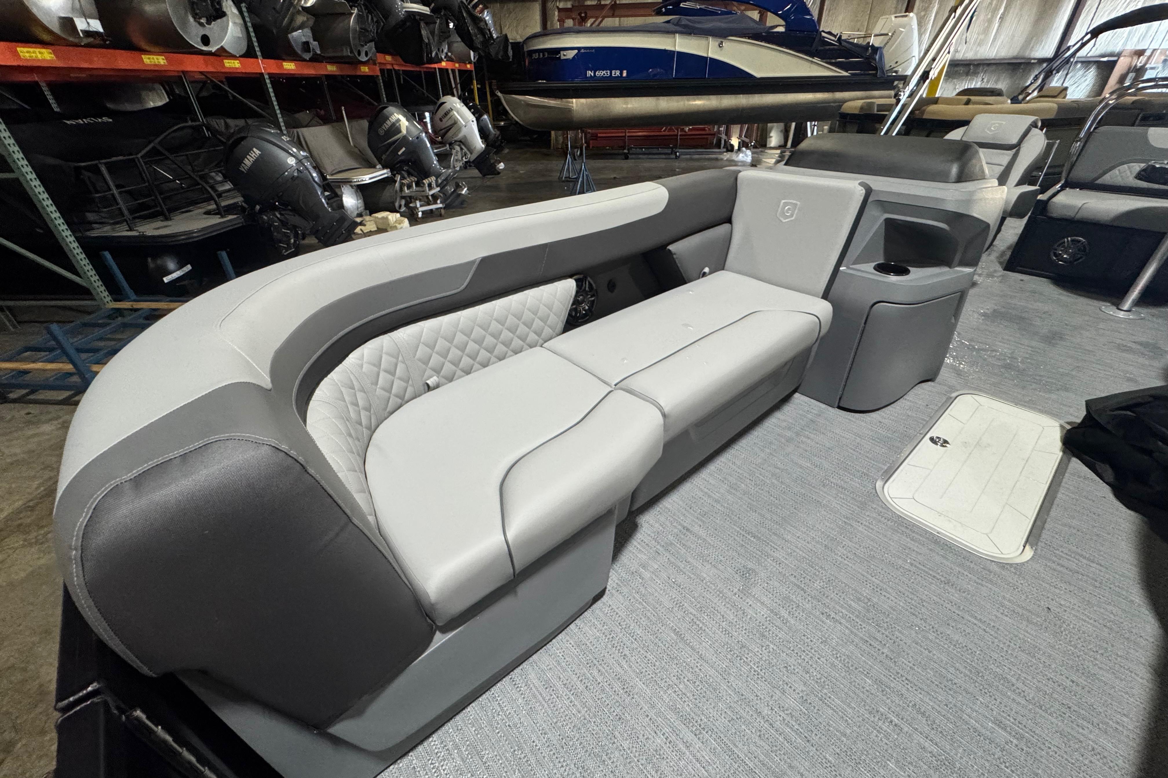 2026 Godfrey Sweetwater 2286 SFL boat interior with gray seating and storage compartments.