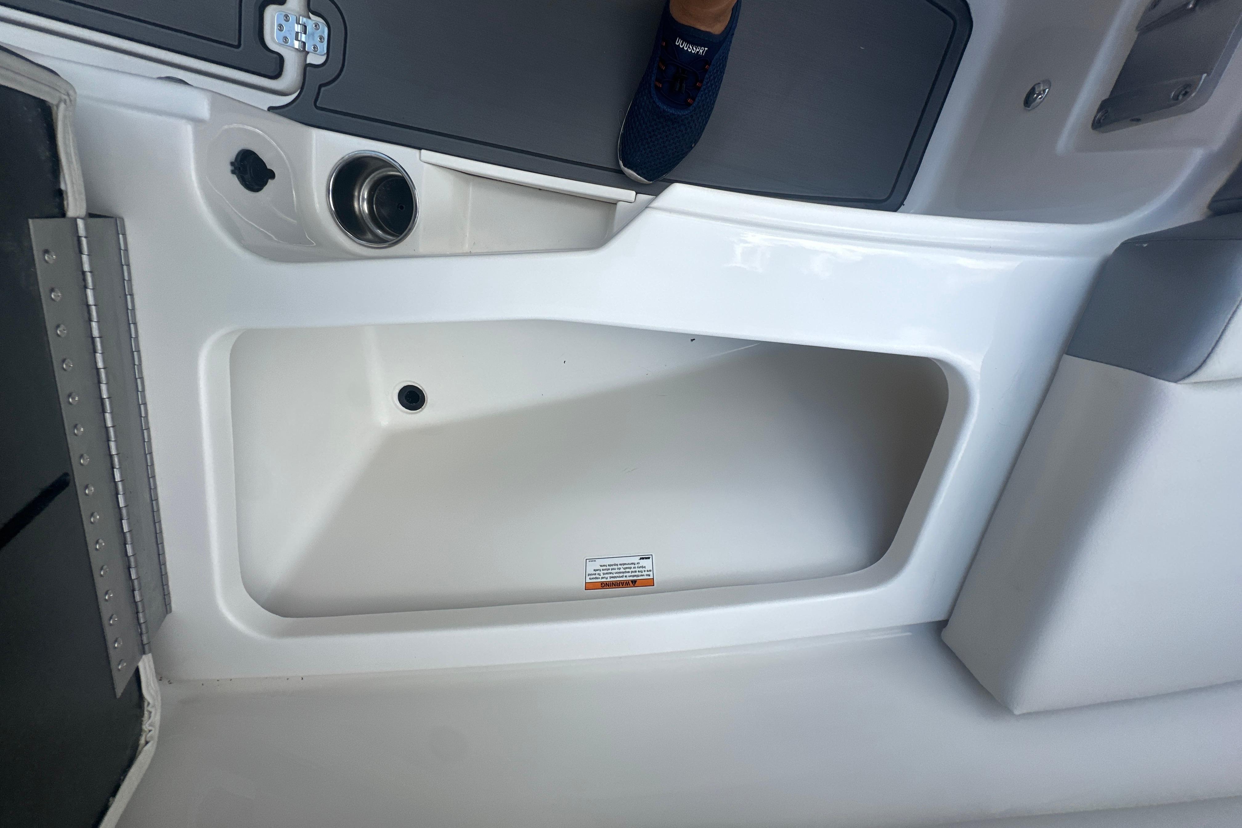 Interior view of 2026 Sailfish 226 DC boat, featuring a storage compartment.