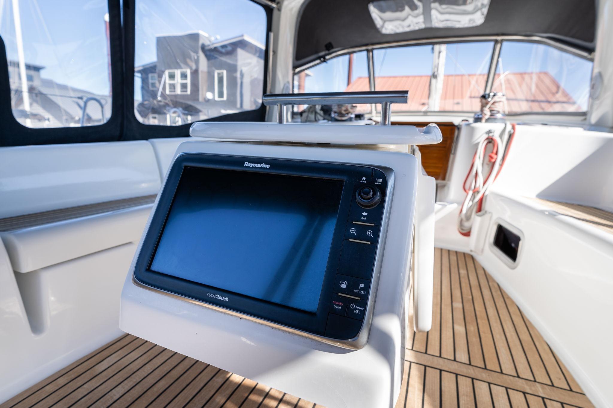 Beneteau Oceanis 50 cockpit with Raymarine display, teak flooring, and modern design, 2013 model.