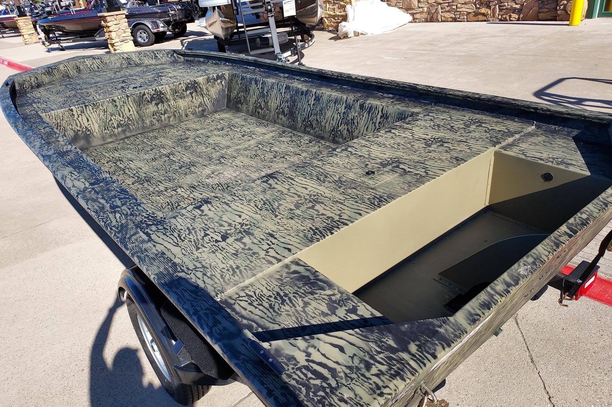 2026 Tracker Grizzly 1754 Utility boat with camouflage design on a trailer.