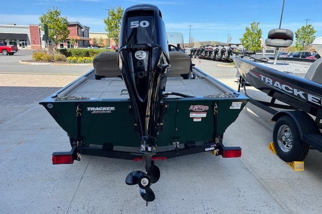 2026 Tracker Bass Tracker Classic Limited boat with 50 HP motor, parked outdoors.
