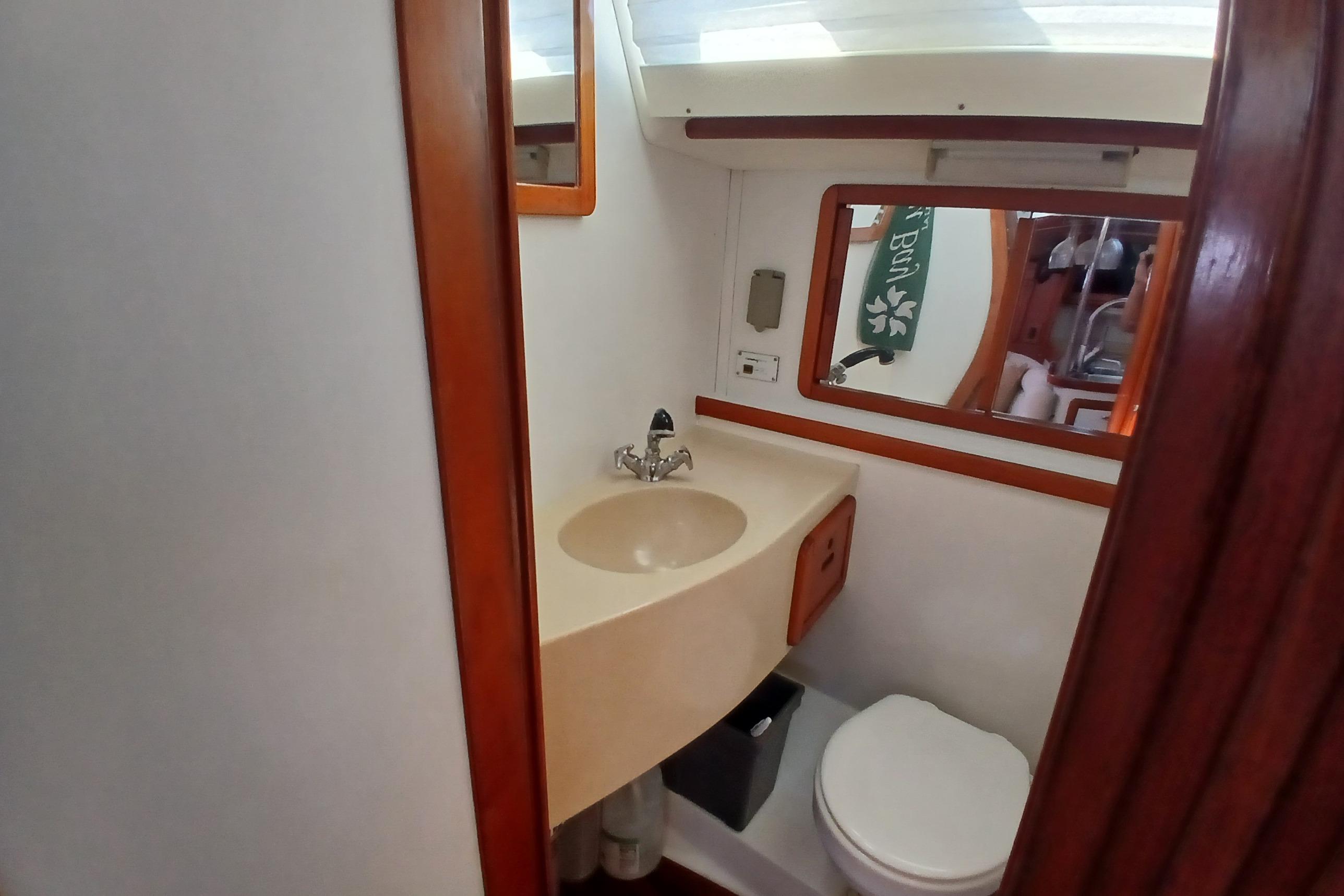 Bathroom interior of 1995 Catalina 42 MkII sailboat with sink and toilet.