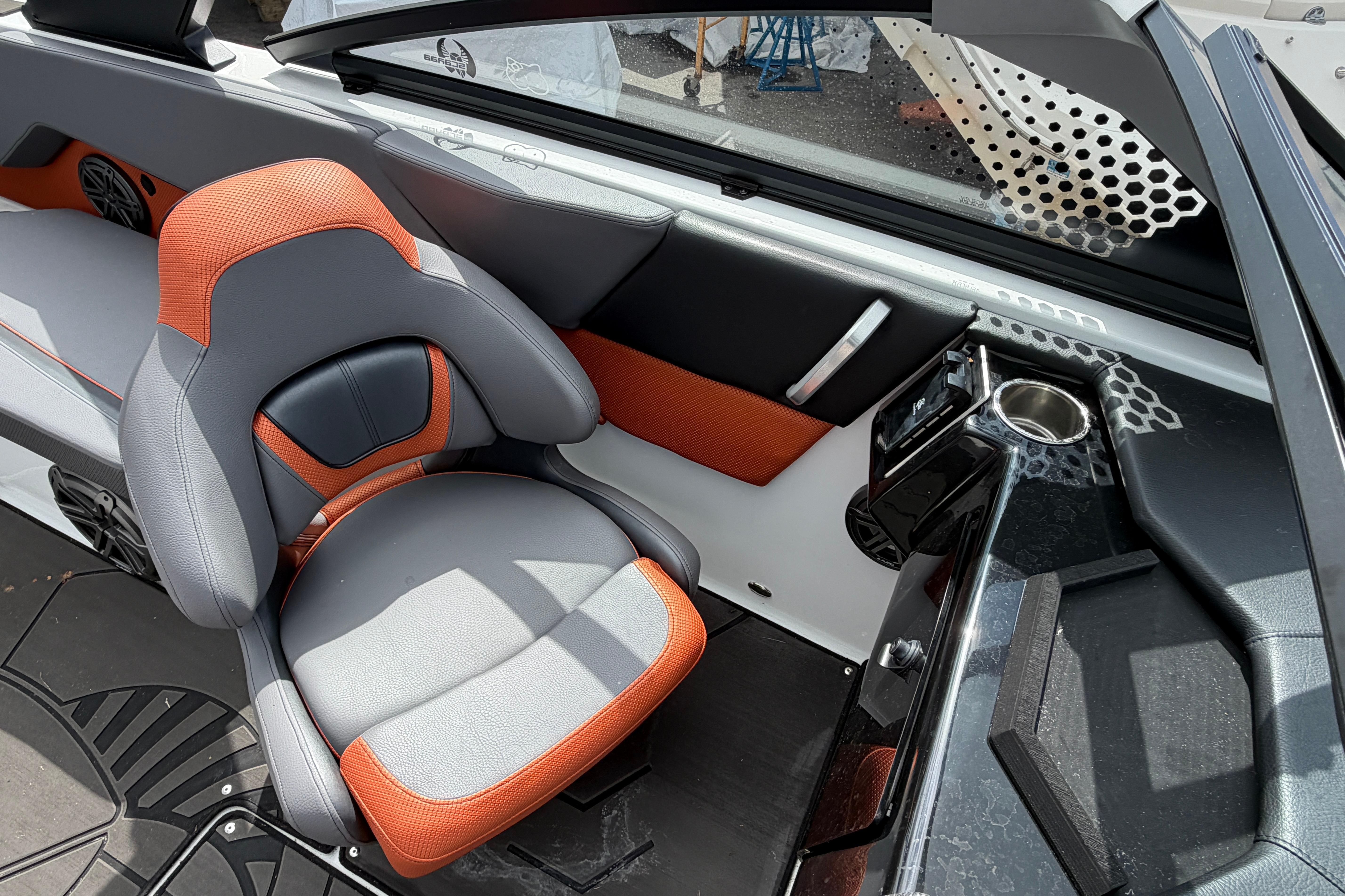 2026 Scarab 235 LX boat interior with orange and gray seating, modern design features.