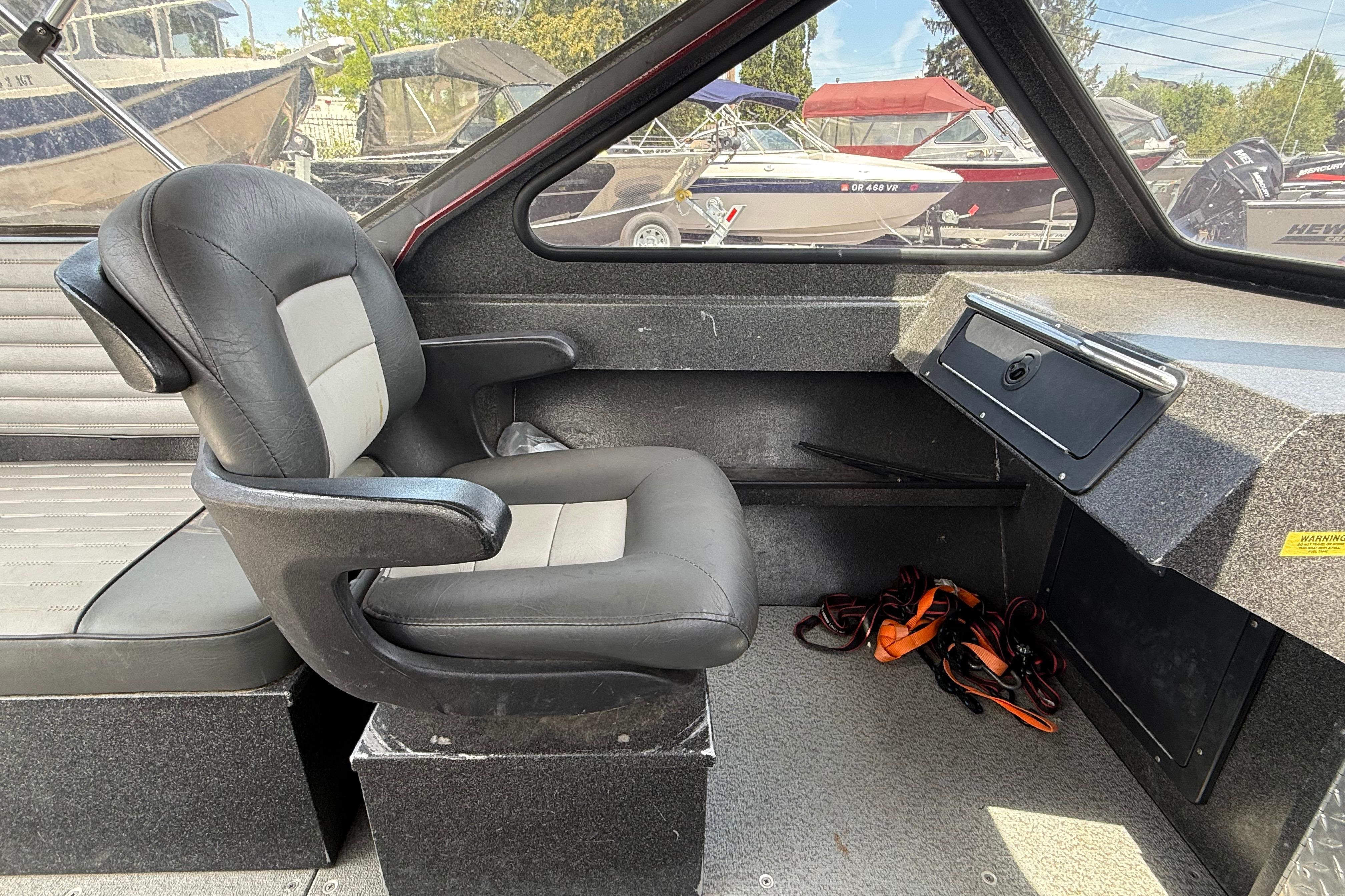 Interior of a 2005 Willie Raptor 21' boat with a black captain's chair.