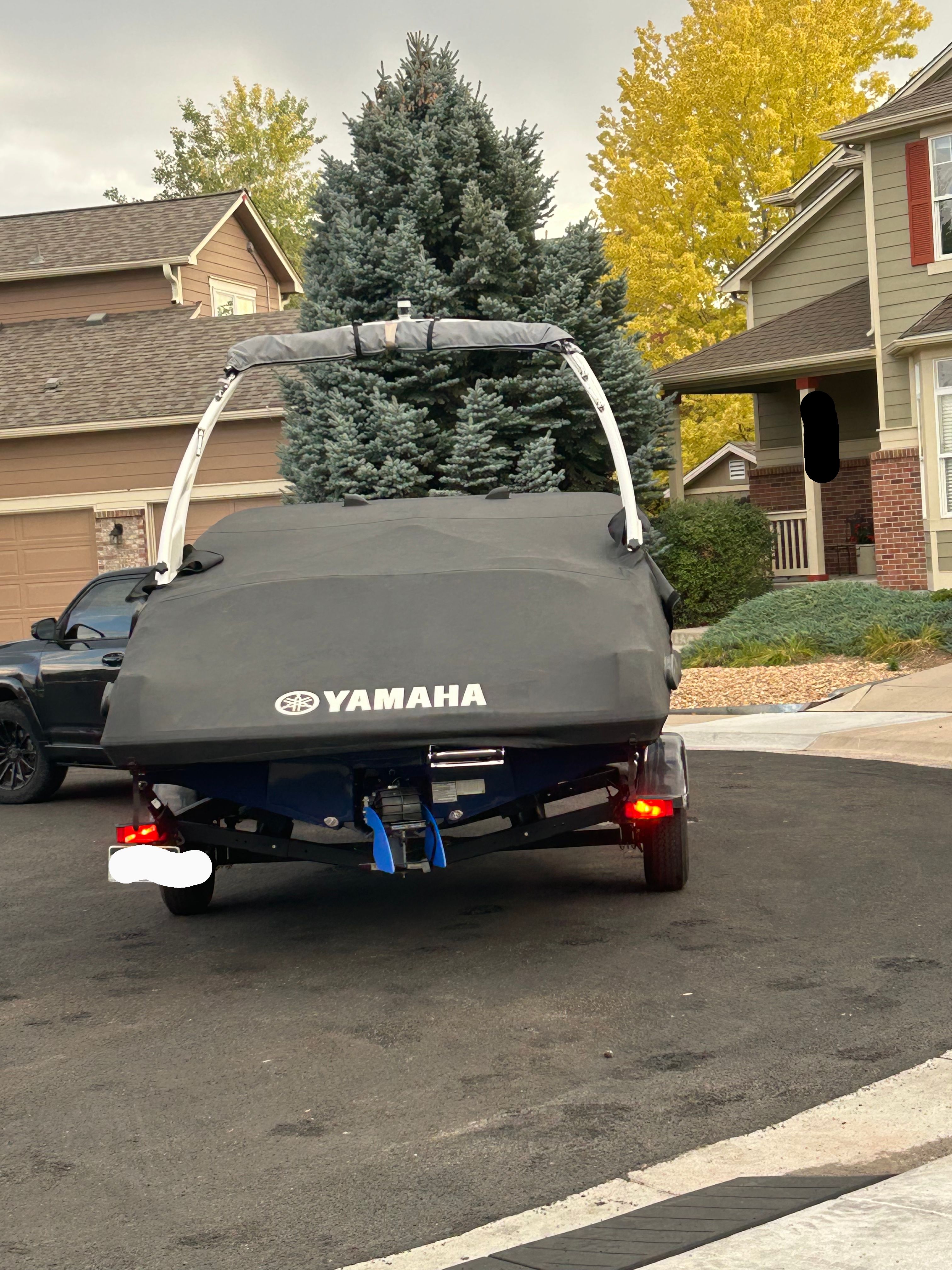2022 Yamaha 195S boat on trailer parked in residential area.