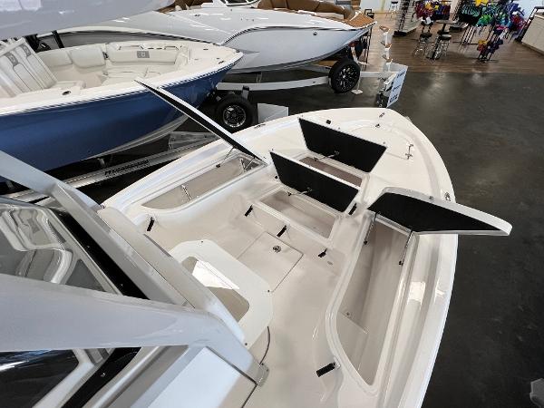 2024 Sea Fox 231 Bay boat with open storage compartments in showroom.