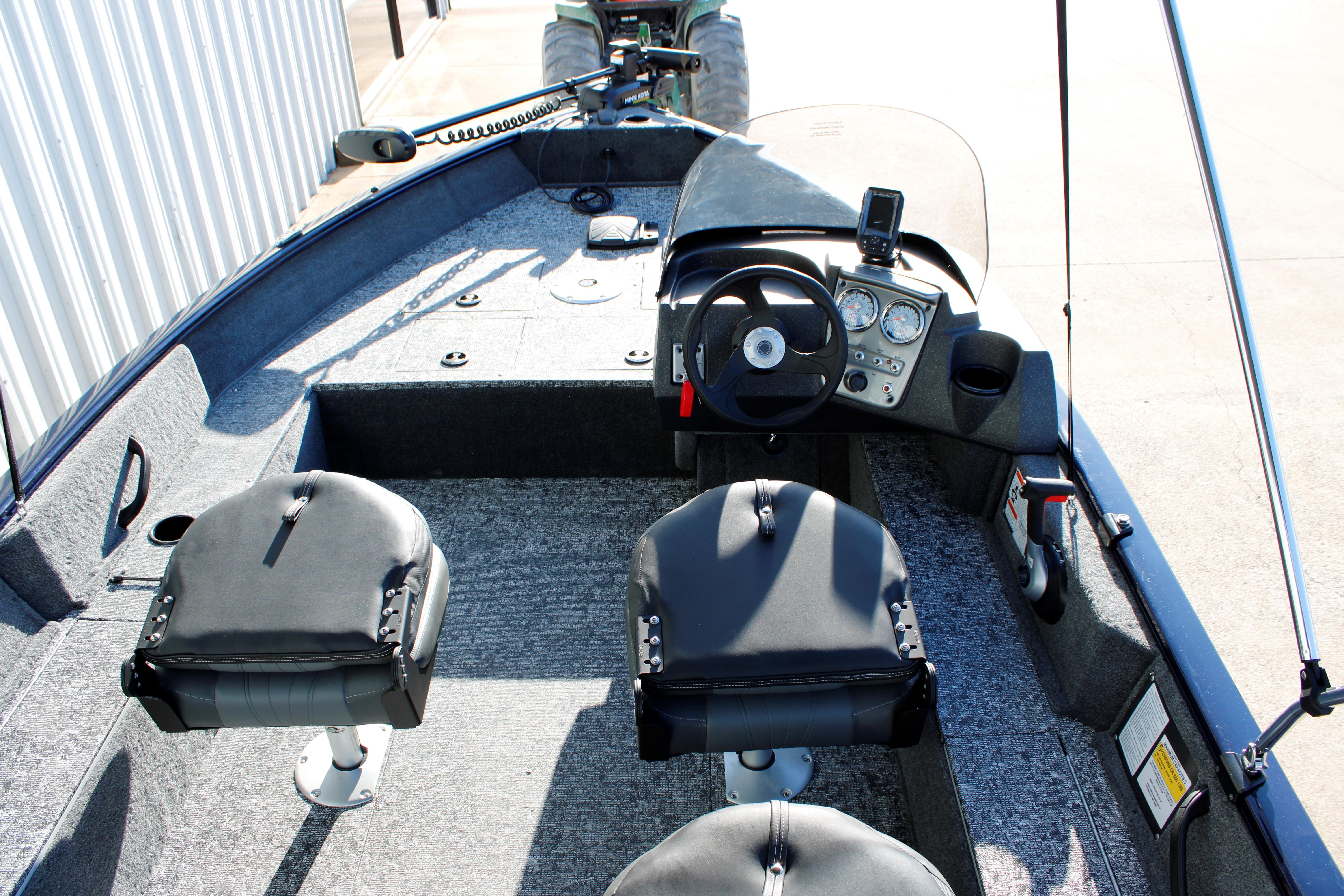 Interior of 2026 Tracker Pro Guide V-16 SC boat with steering console and seating.
