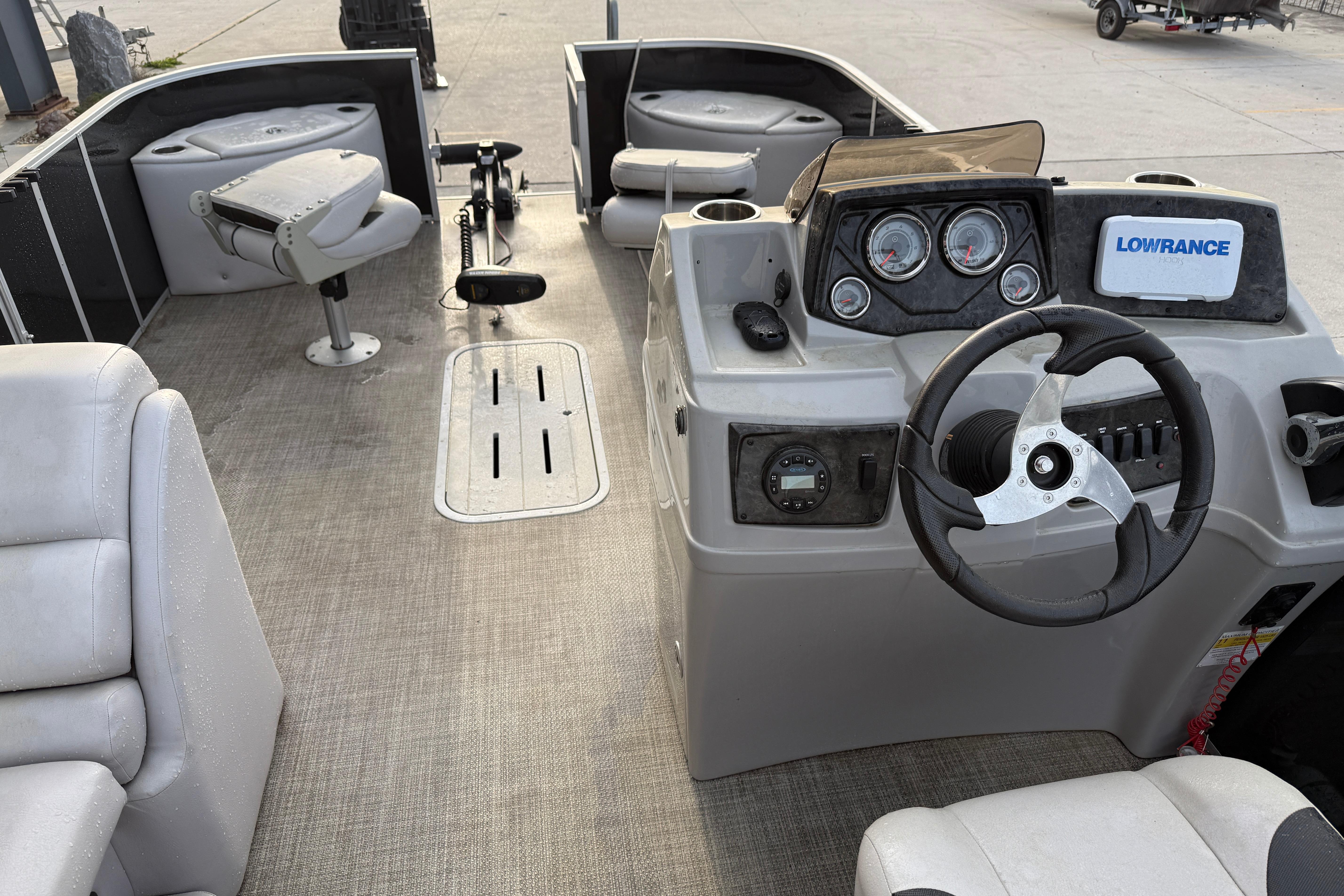 2022 Custom G3 Suncatcher 322FC boat interior with steering console and seating.