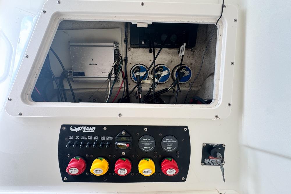 Control panel of a 2018 Mako 284 Center Console boat, showing wiring and switches.