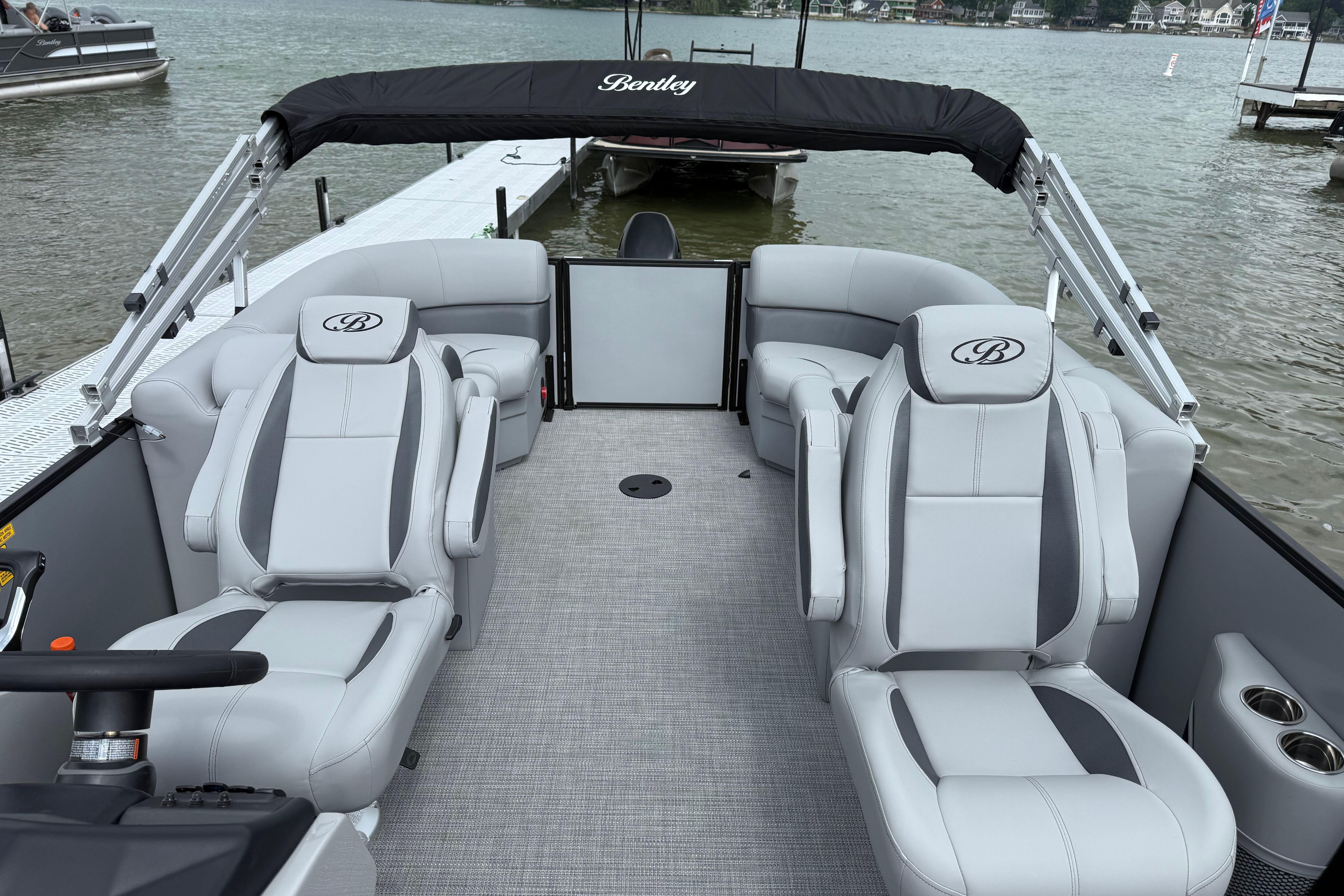 2026 Bentley Pontoons Legacy 220 Navigator interior with luxurious seating on a lake.