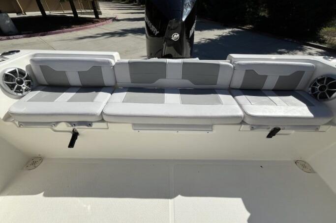 2025 Mako 214 Center Console boat with cushioned seating and modern design.