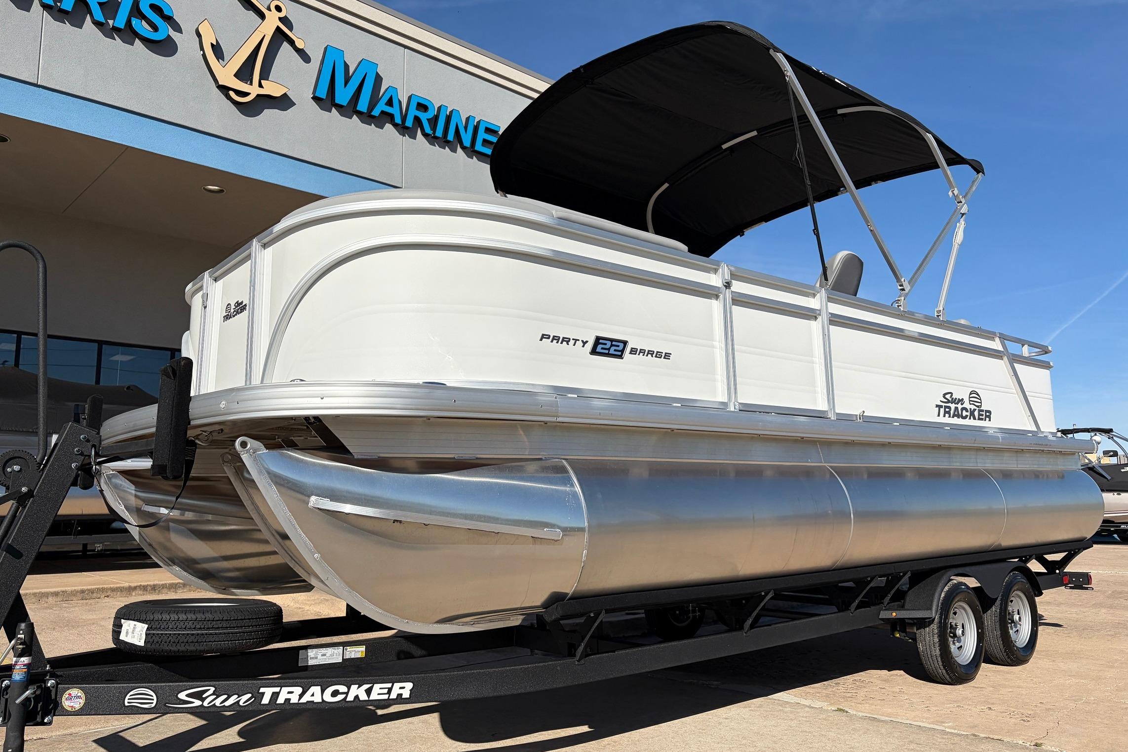2026 Sun Tracker Party Barge 22 RF XP3 pontoon boat on trailer at dealership.