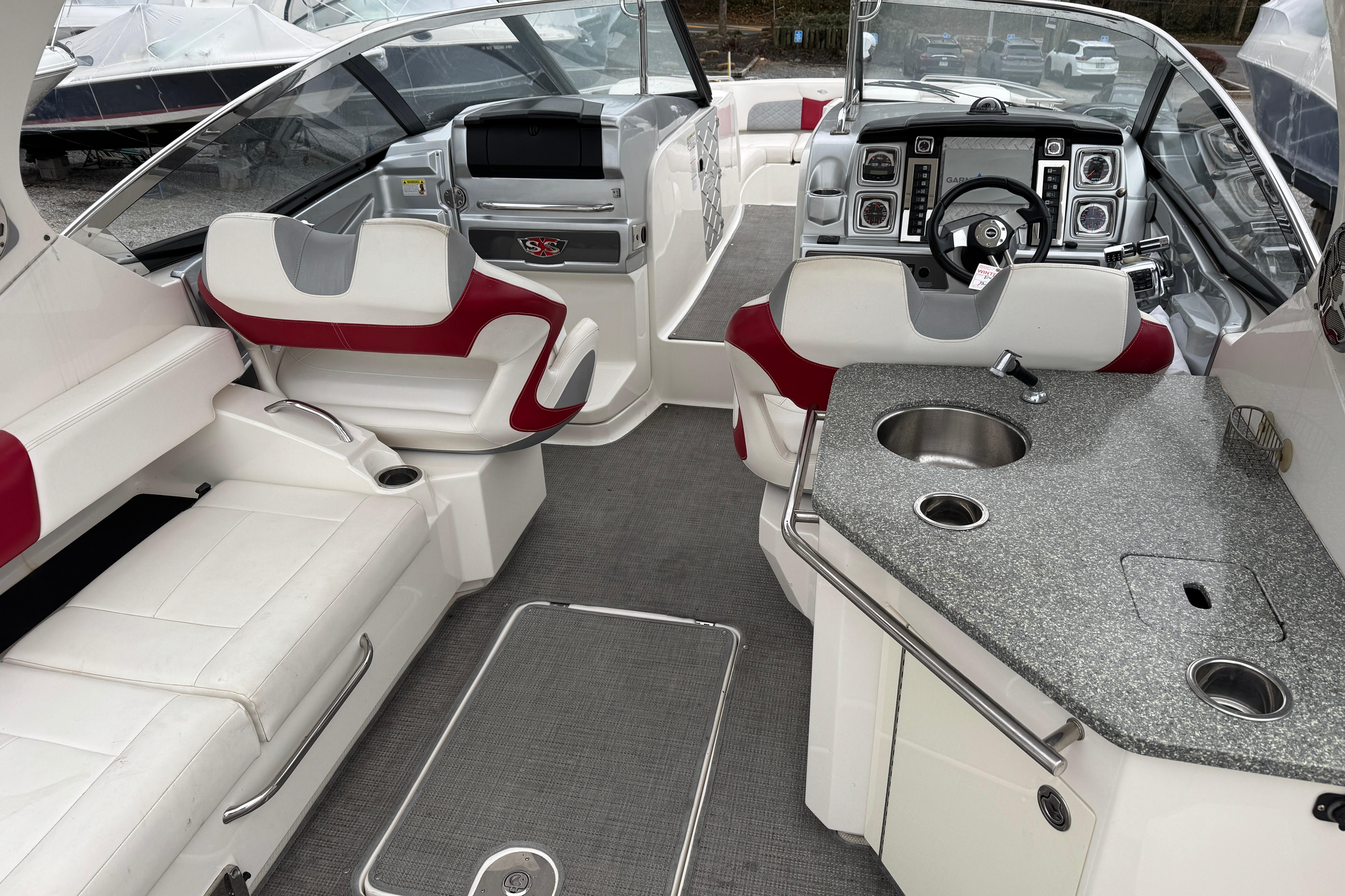 2012 Chaparral 327 SSX boat interior with luxurious seating and modern dashboard.