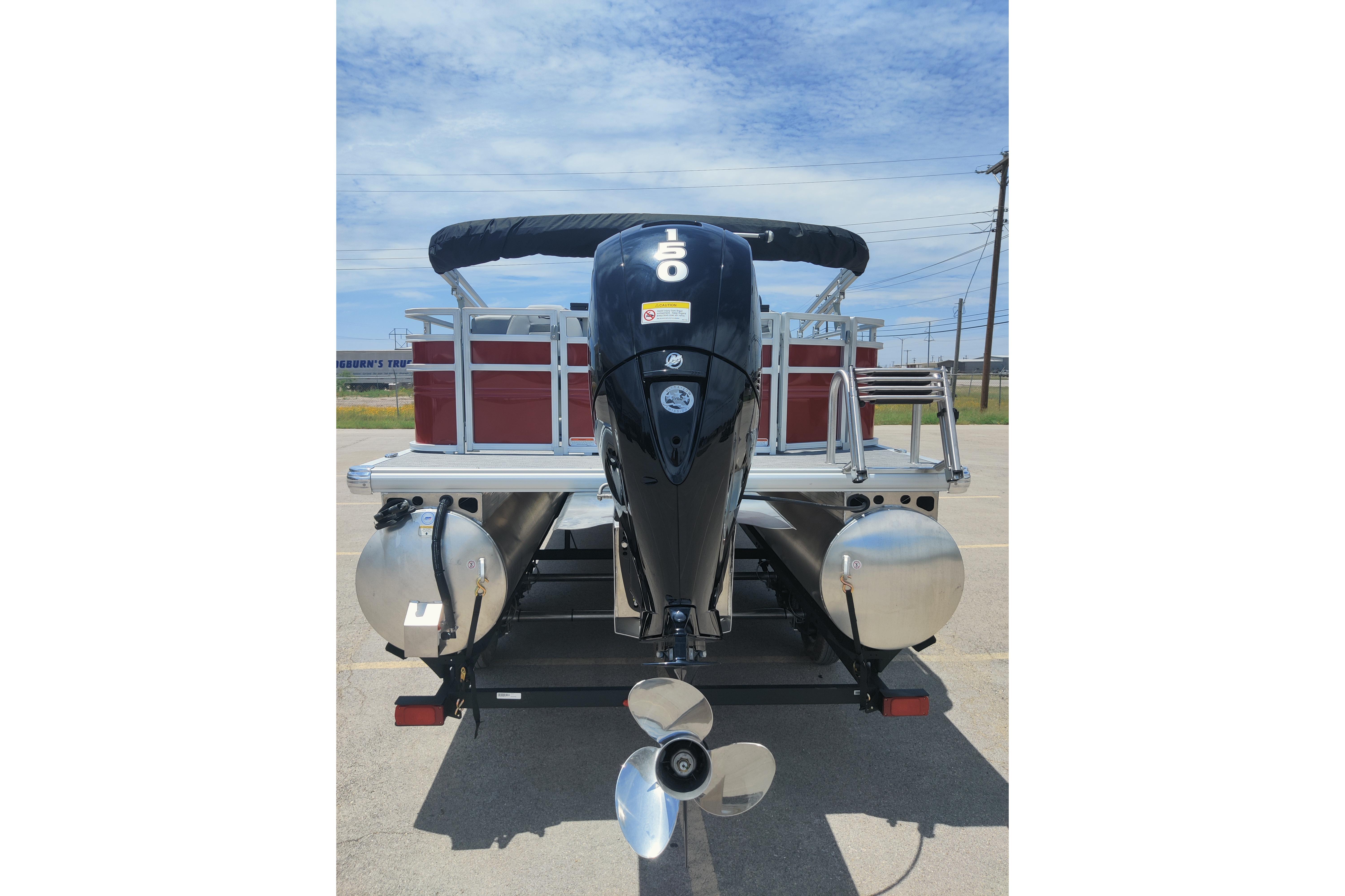 2026 Sun Tracker SportFish 22 DLX pontoon boat with powerful outboard motor.