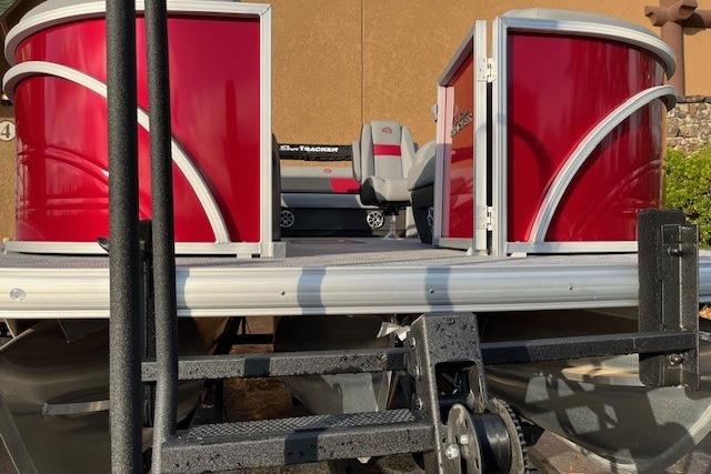 2026 Sun Tracker Party Barge 22 RF XP3 pontoon boat with red exterior on trailer.