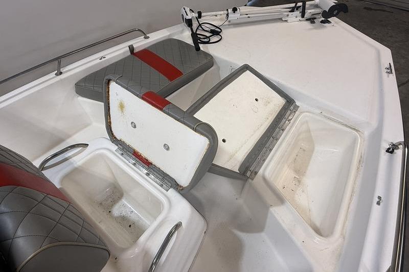 1996 Century 1800 Center Console boat interior with open storage compartments and seating.