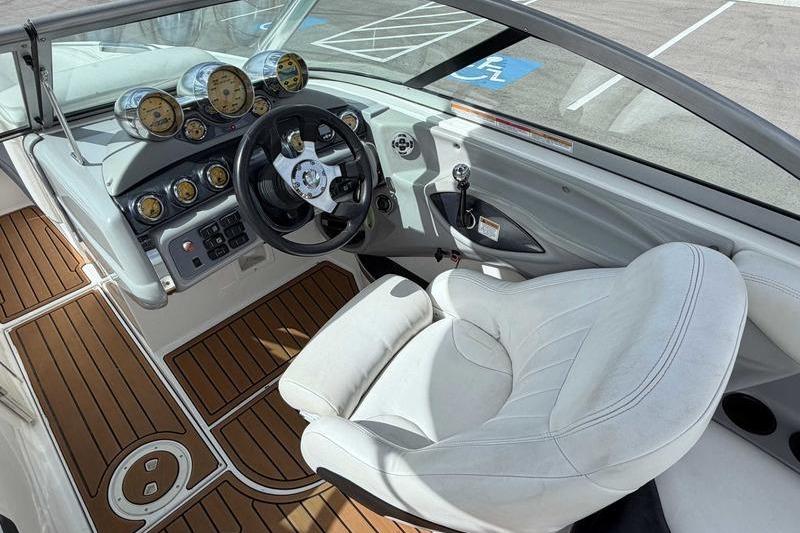 2004 MasterCraft XStar boat interior with white seating and wood-patterned flooring.