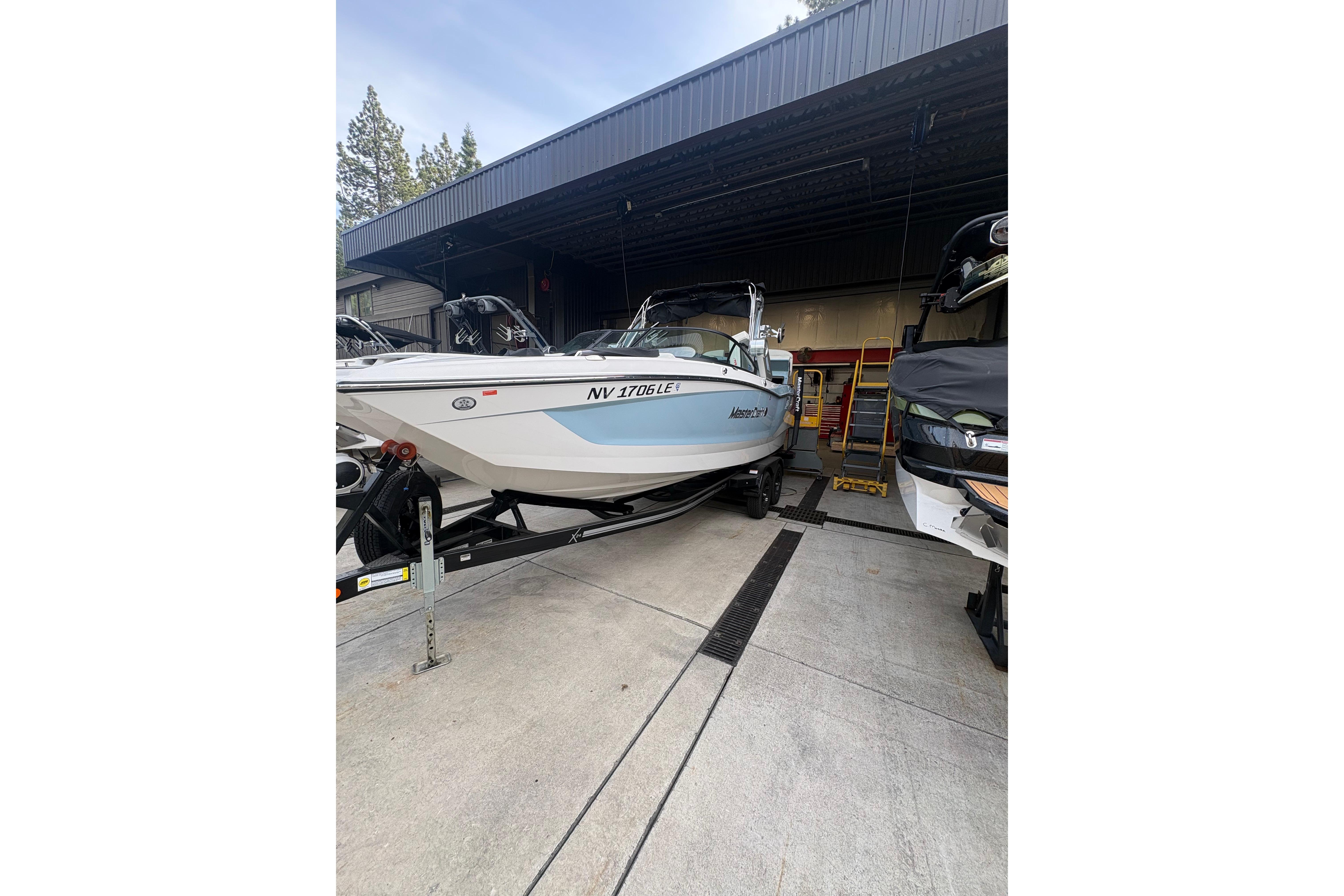 2022 MasterCraft X24 boat in storage, featuring sleek design and modern amenities.