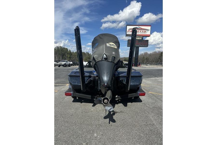 2020 Skeeter FXR21 boat with outboard motor, parked outdoors under a cloudy sky.