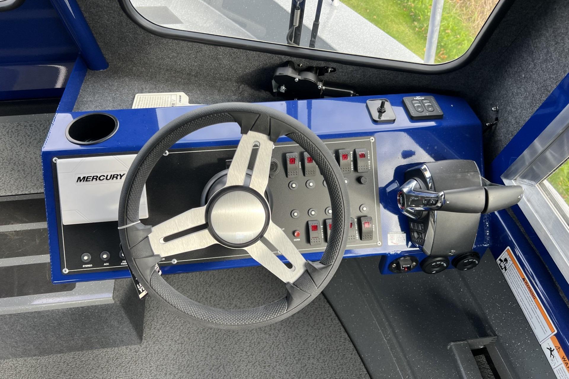 2024 Spartan 26 Maximus Pro XL boat dashboard with steering wheel and control panel.