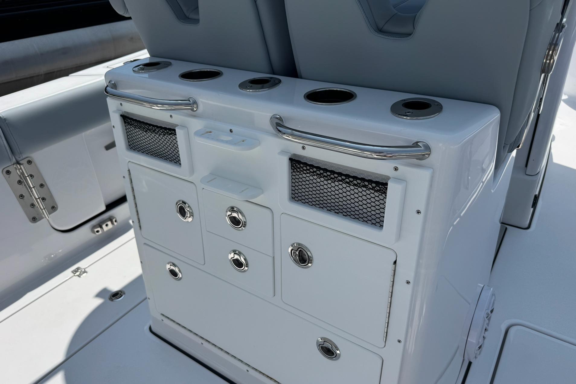 2026 Sportsman Open 262 Center Console boat interior with storage compartments and cup holders.