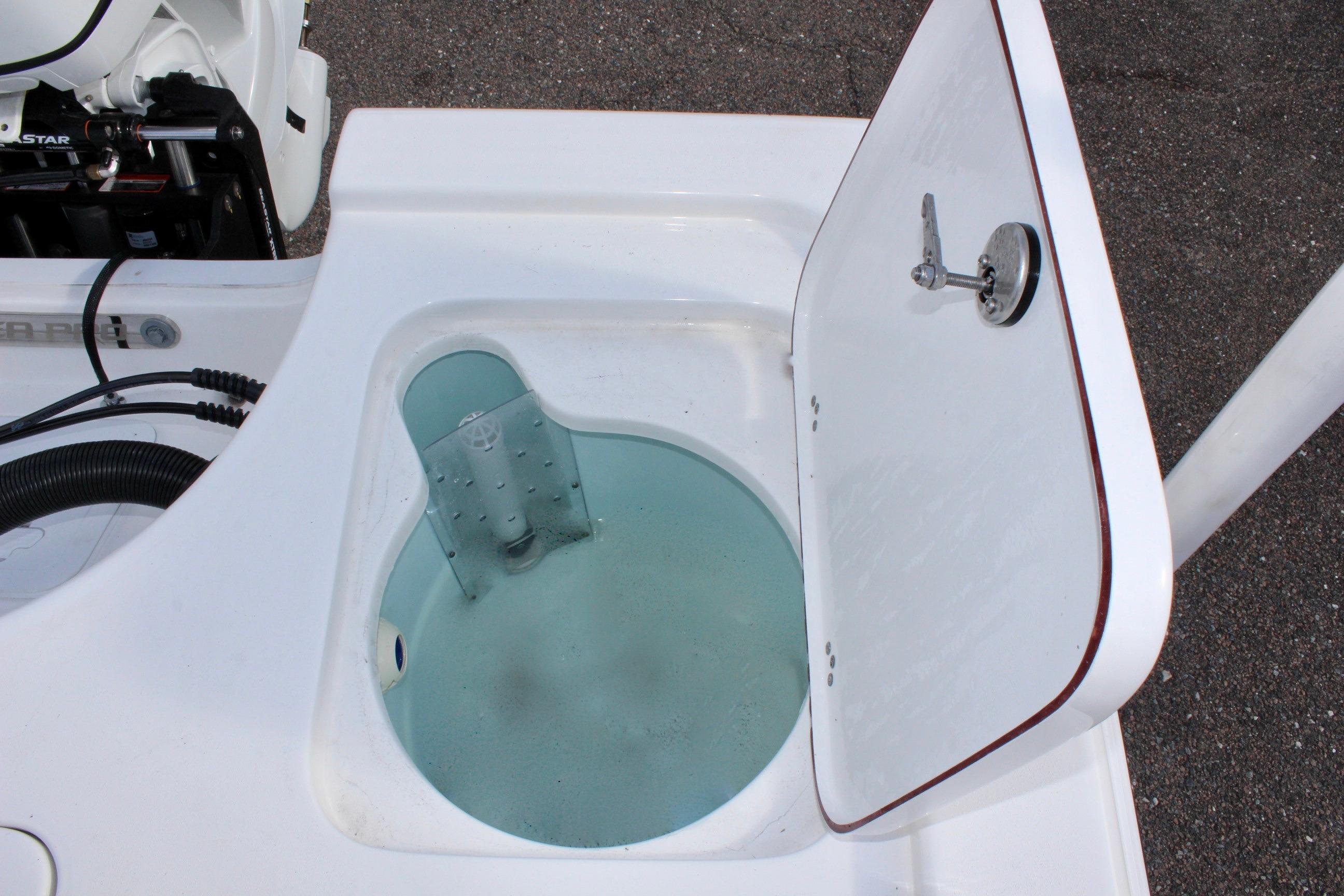 Livewell compartment on a 2025 Sea Pro 230 Bay boat, open lid showing interior.