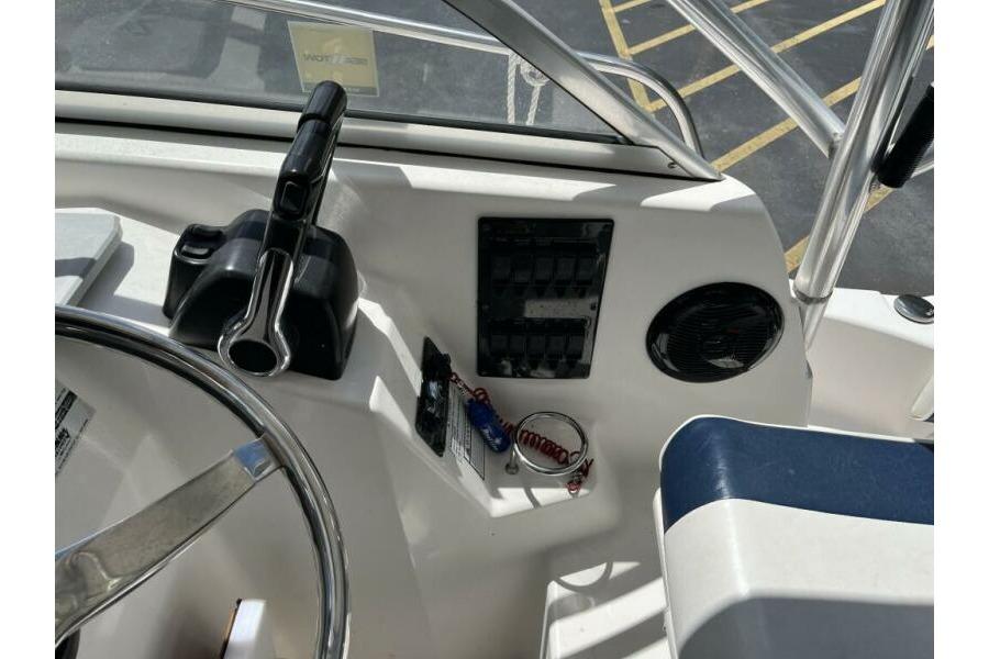 2006 Century 2400 Walk-Around boat dashboard with steering wheel and control panel.