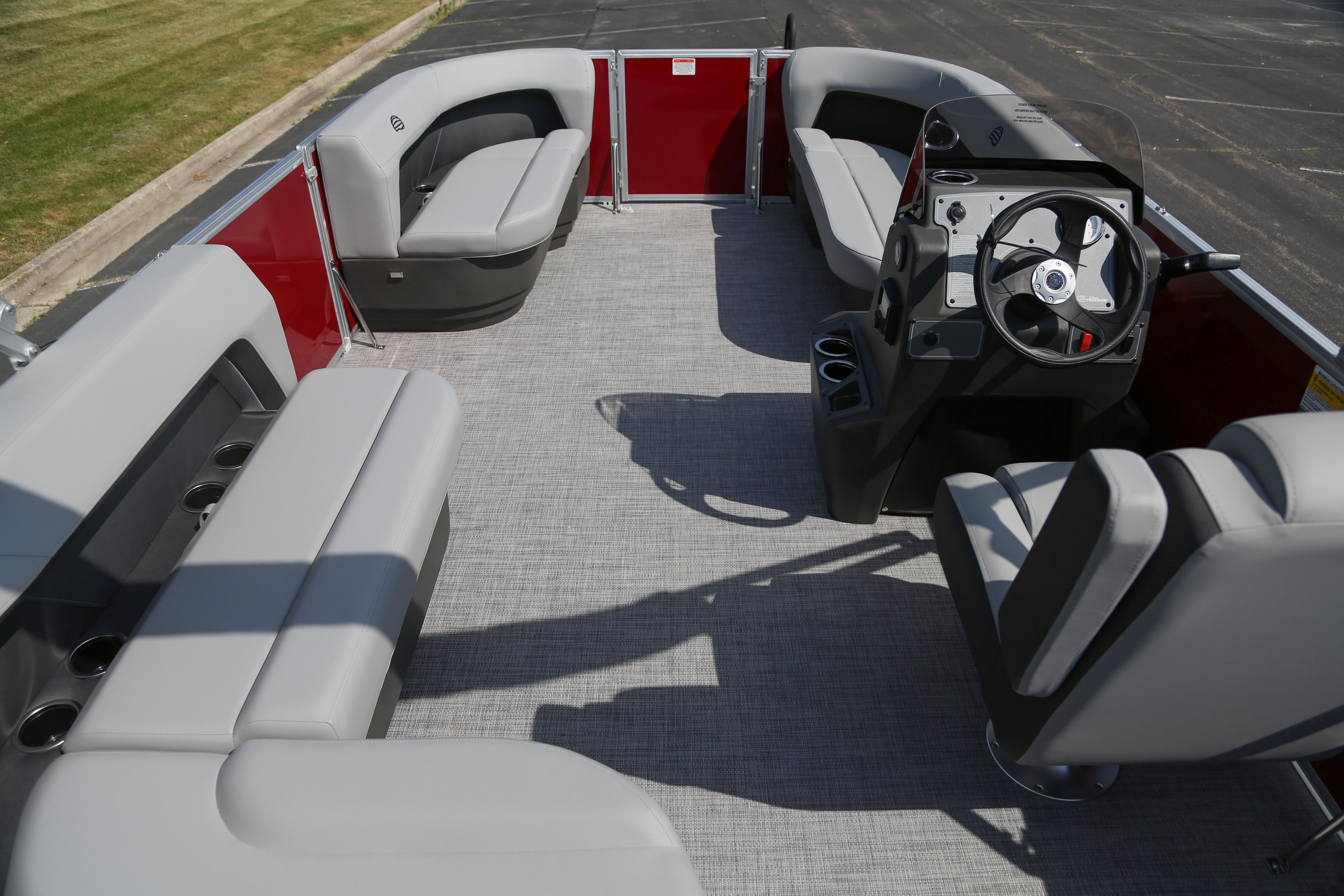 2026 Sun Tracker Party Barge 16 DLX interior with gray seating and steering console.