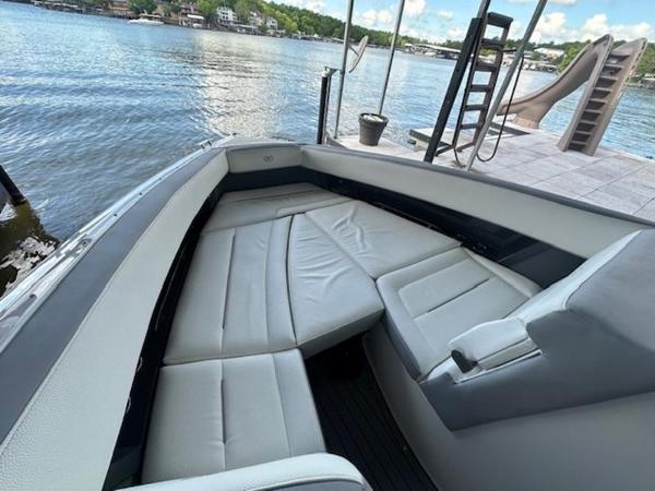 2022 Cobalt A36BR boat with spacious seating, docked by a serene lake.