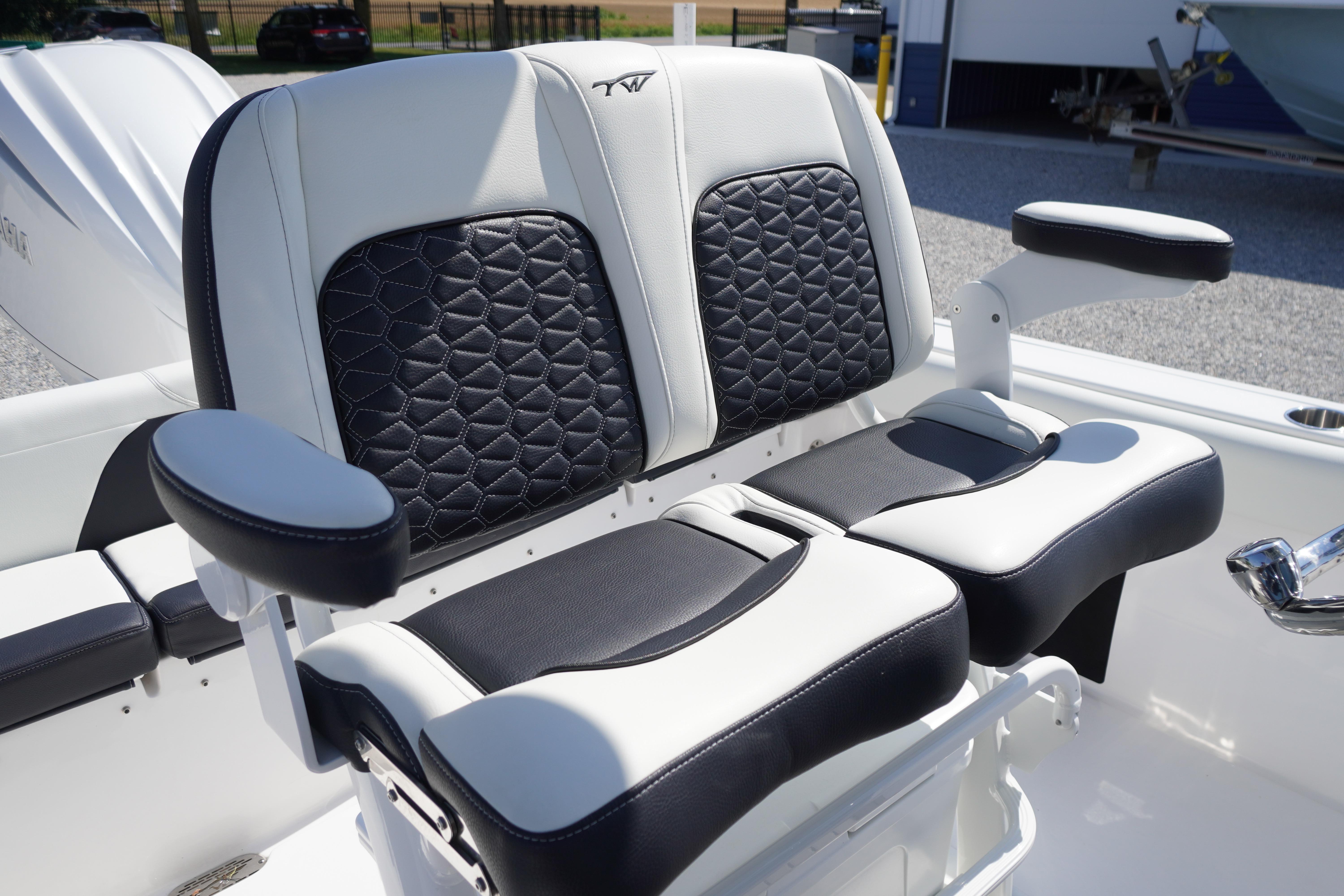 2025 Tidewater 232 SS boat seats with black and white upholstery, featuring armrests.