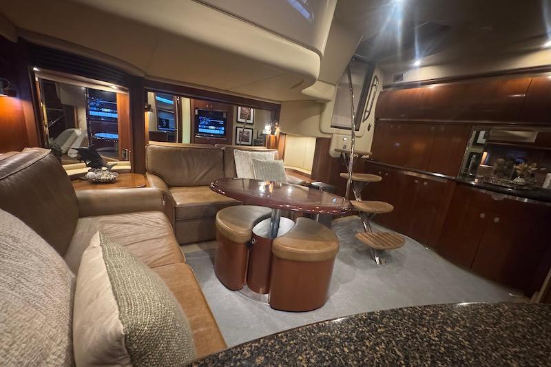 Luxurious interior of a 2005 Sea Ray 500 Sundancer yacht with elegant seating and dining area.