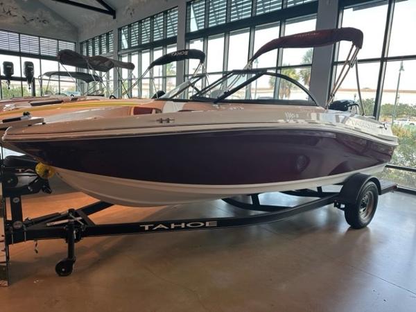 2023 Tahoe 185 S boat on display in a showroom.