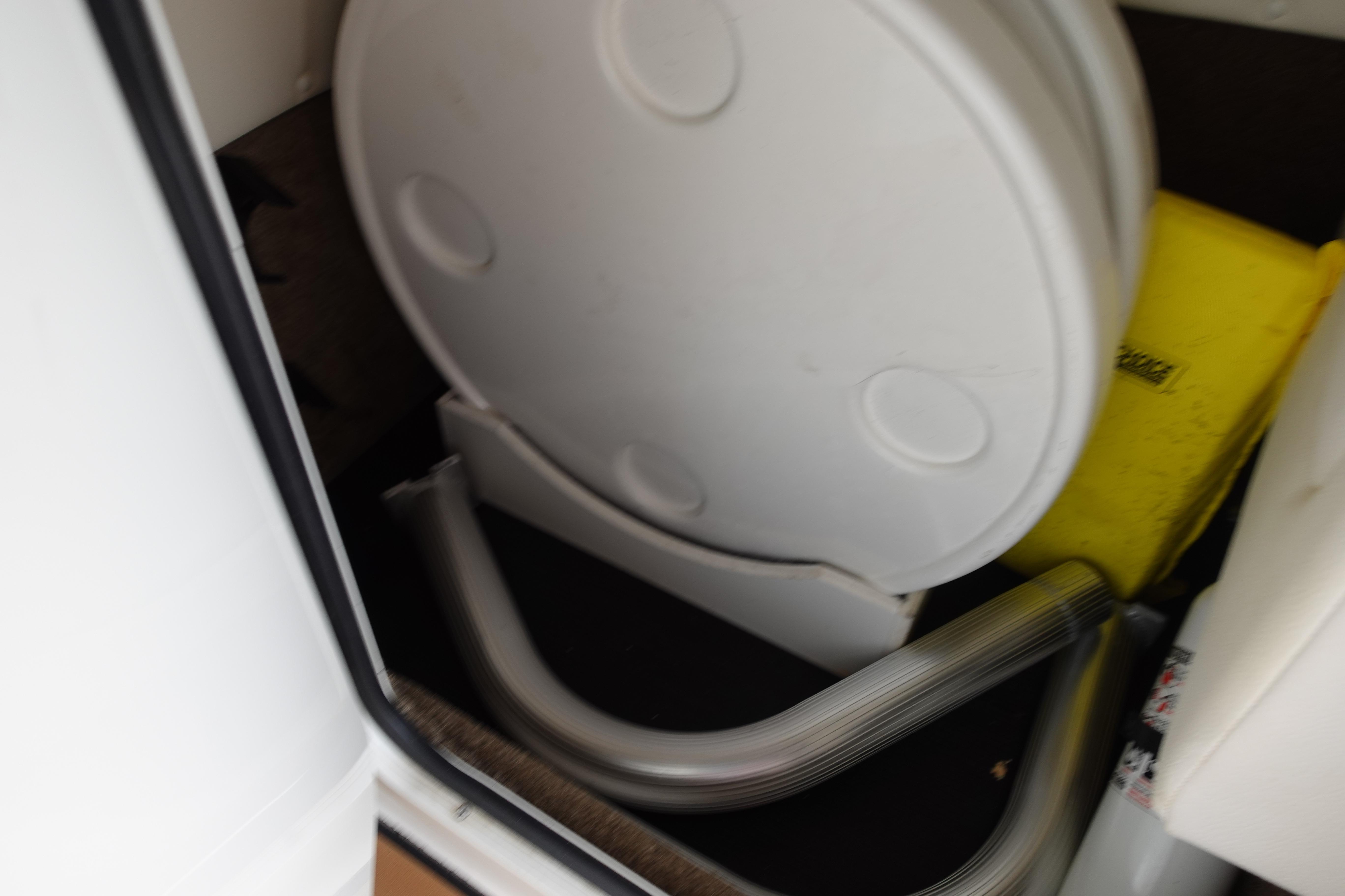 Storage compartment in a 2018 Sea Ray SDX 270 boat with life jackets and equipment.