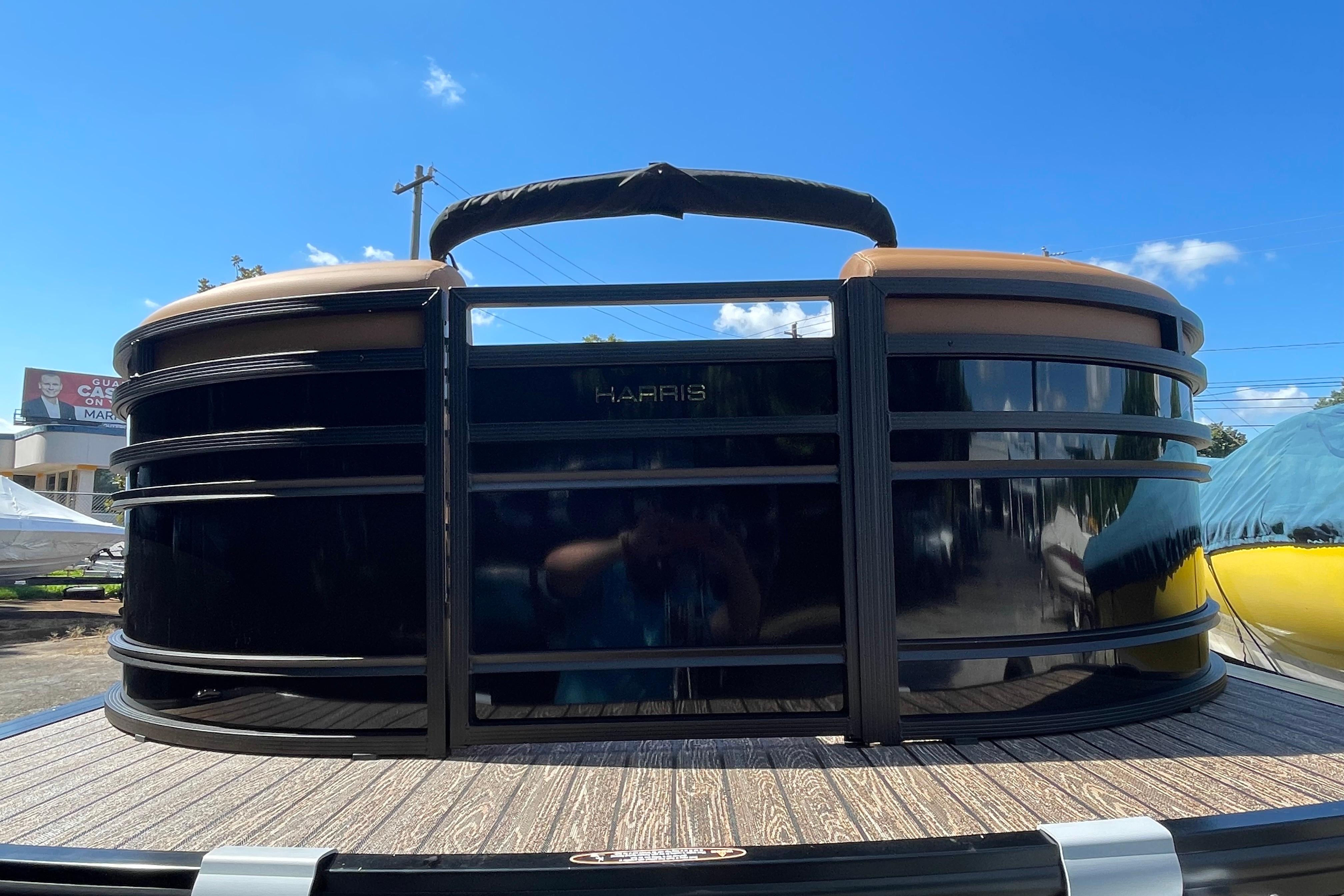 2026 Harris Solstice 250 SLDH pontoon boat, sleek design under clear blue sky.
